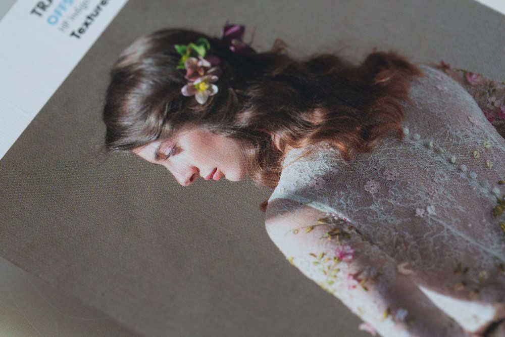 A side profile view shows delicate floral embellishments in dark hair and a soft lace garment.