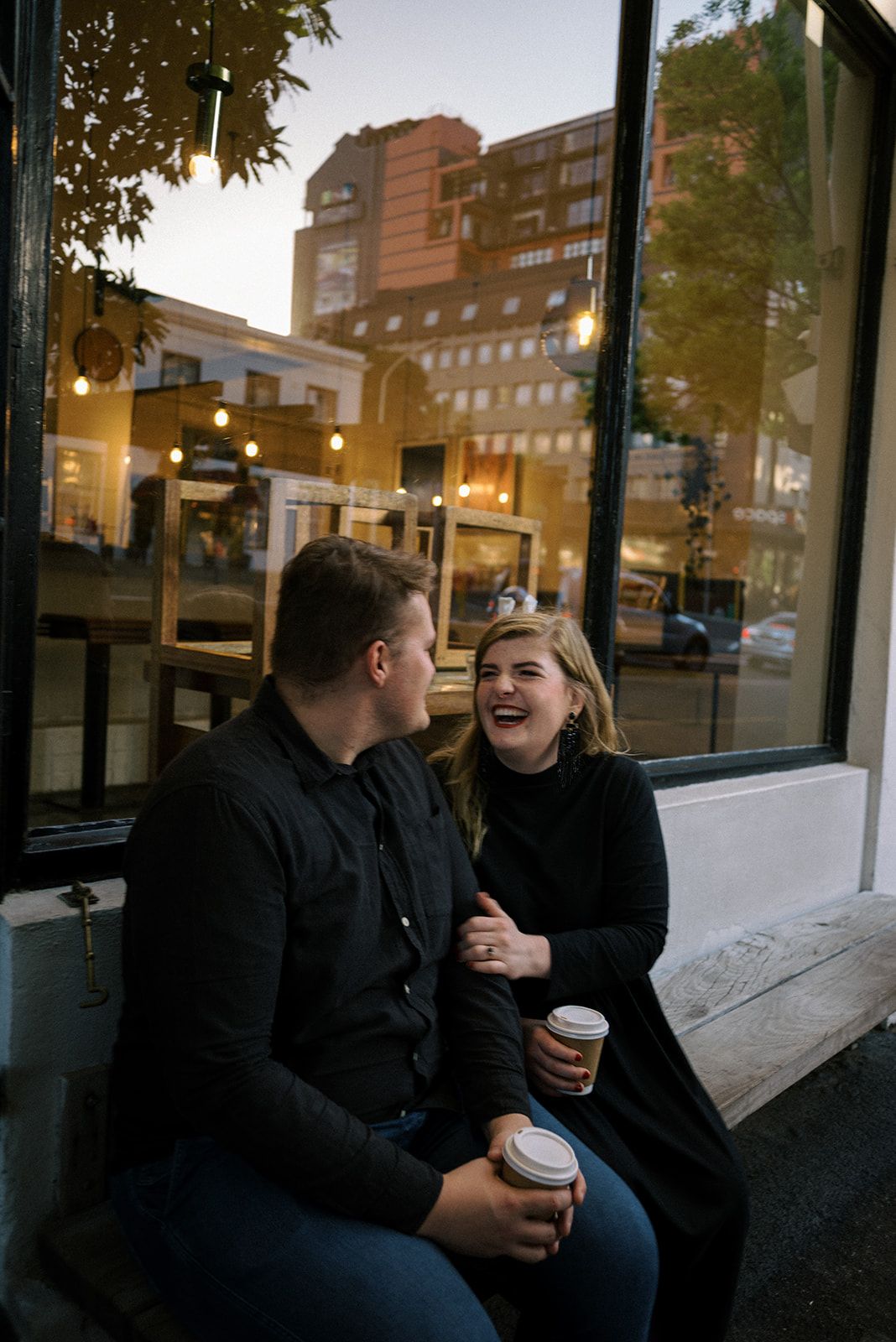 A cozy coffee date scene outside a cafe during golden hour.