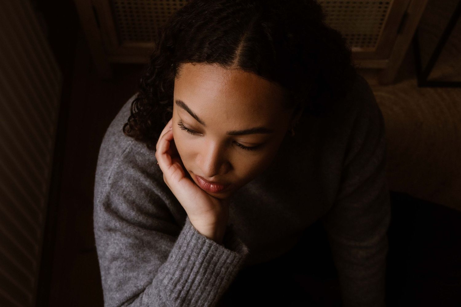 Moody portrait in warm lighting showing peaceful contemplative moment.