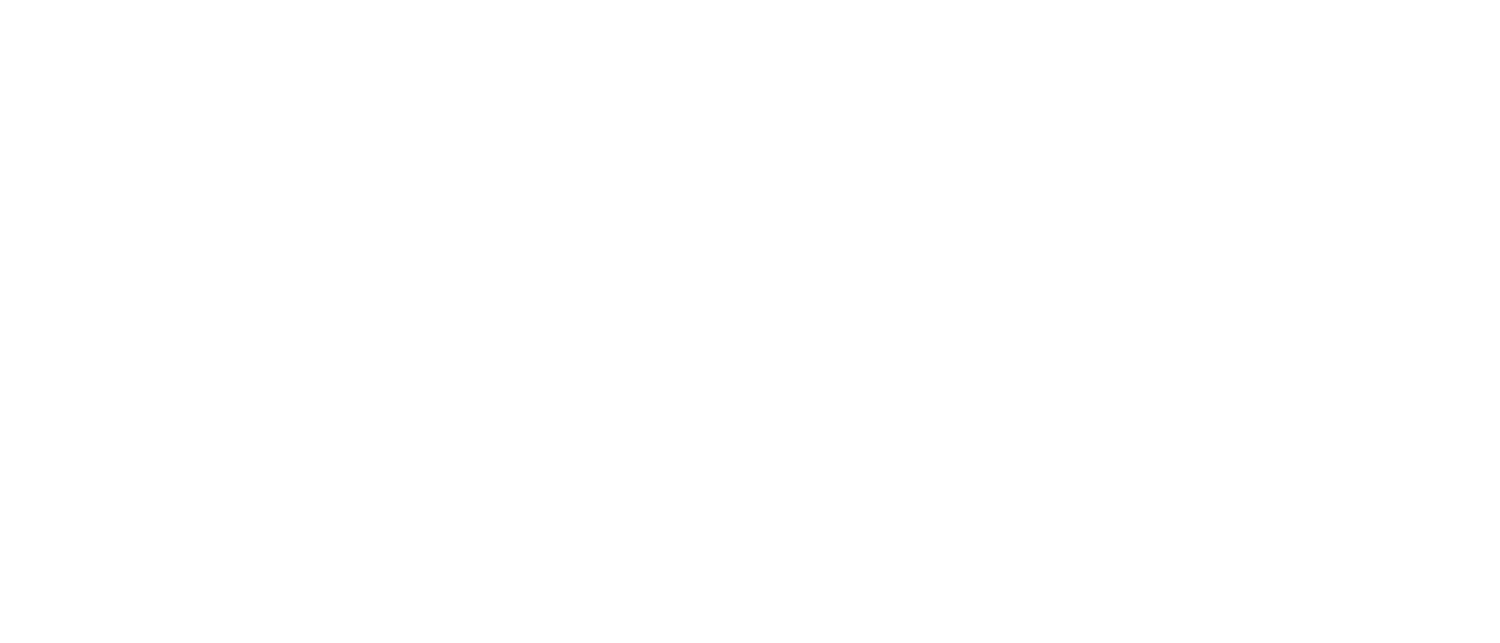 A white handwritten signature or autograph displayed in cursive text against a black background.