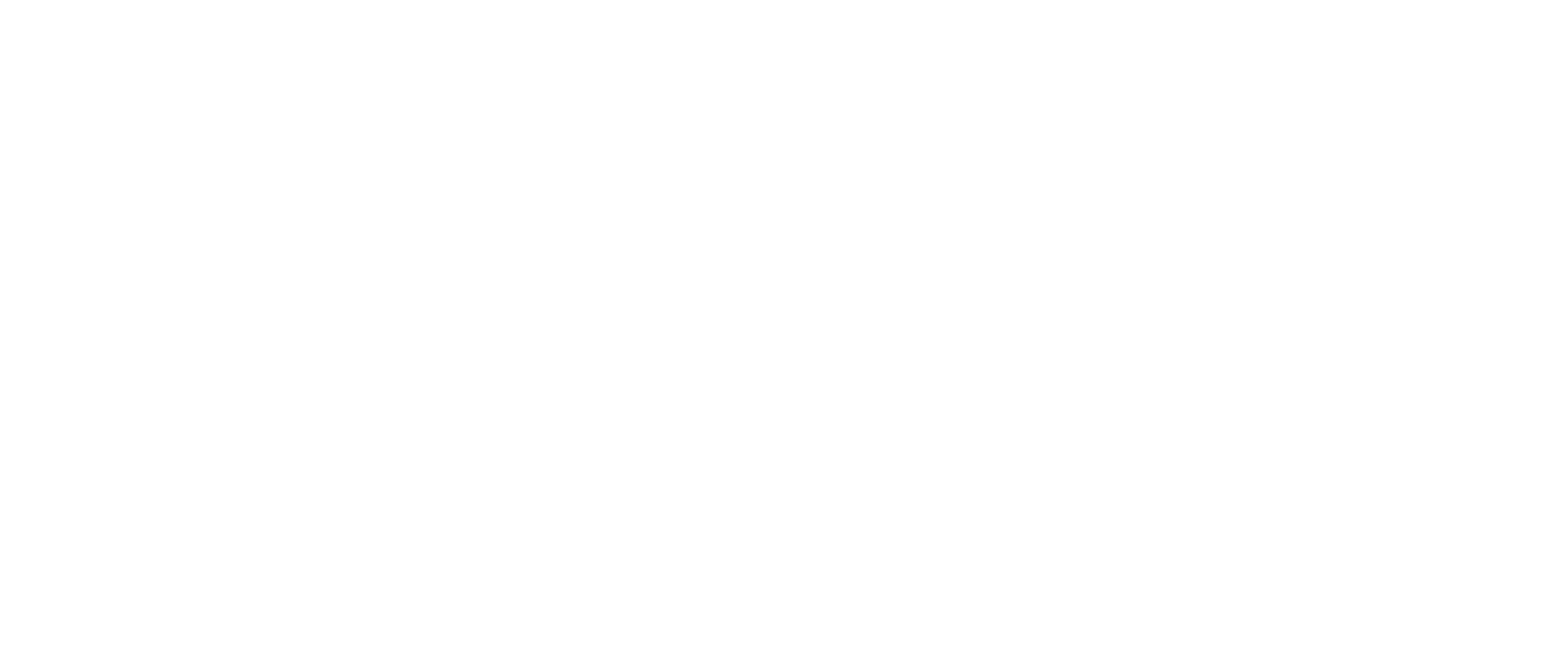 White neon text against black background displays a handwritten cursive message 'Your love story is art'.