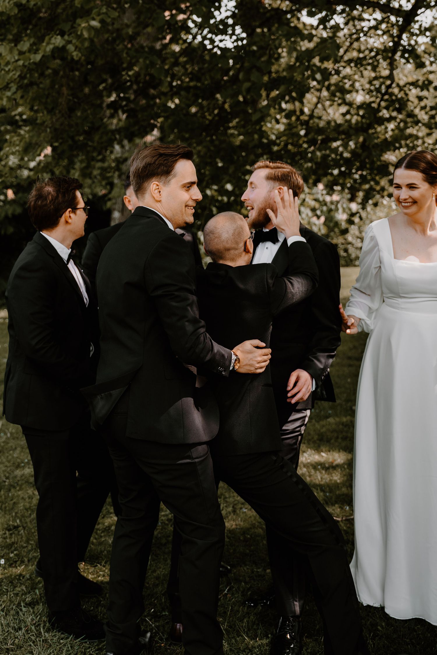 A sequence of candid wedding party photos showing groomsmen in dark suits and bridesmaids in white dresses gathered outdoors.