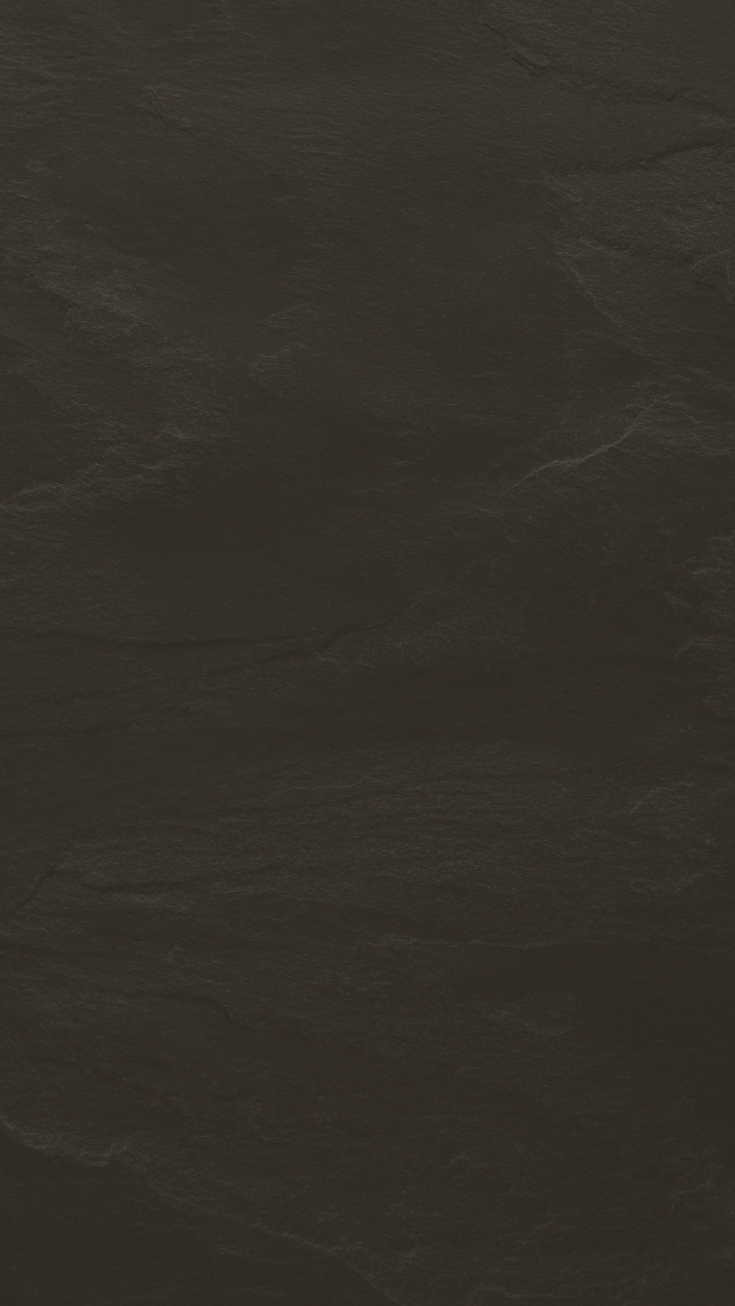 Dark gray textured background with slate-like natural stone pattern.