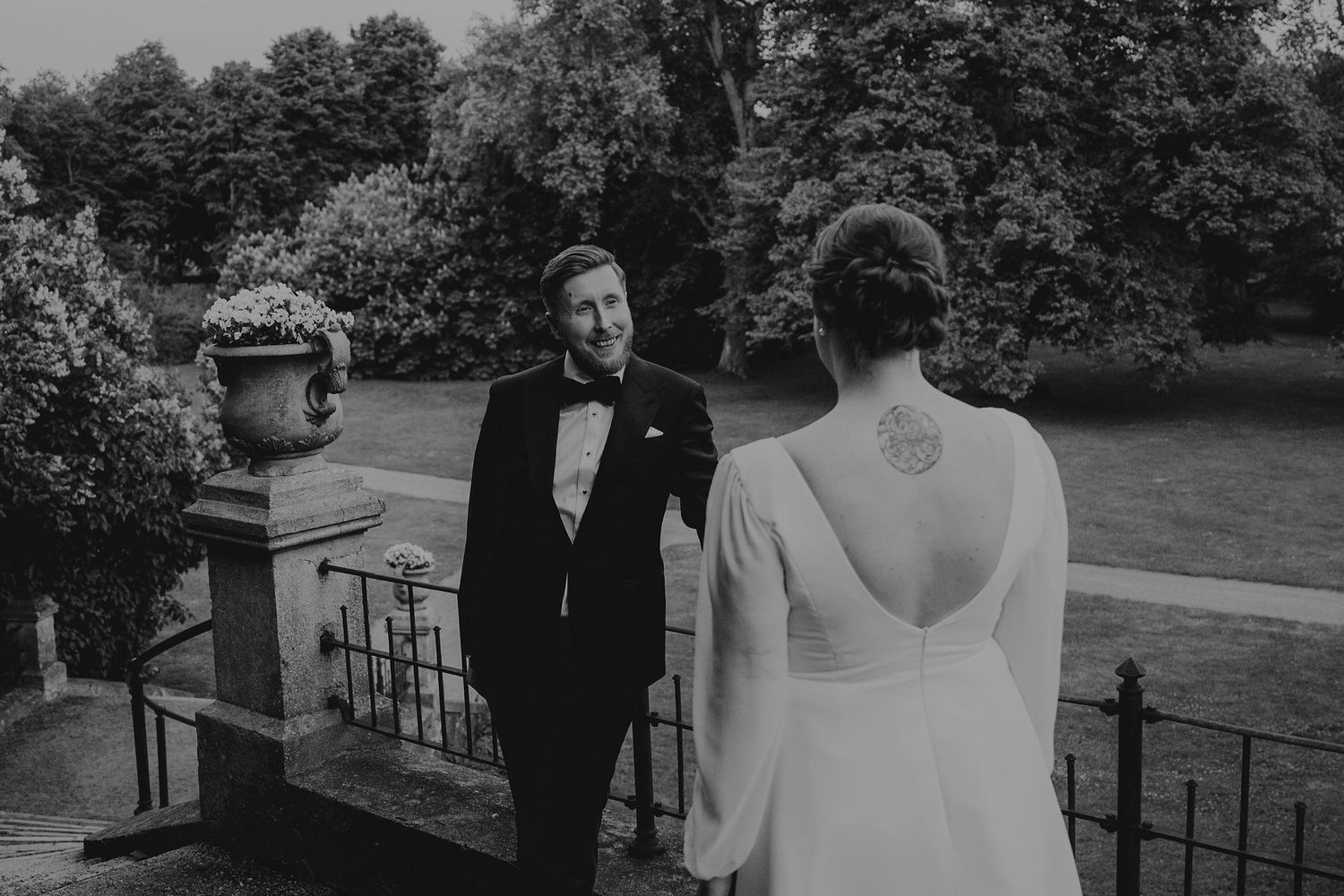 Black and white wedding photographs displayed in a filmstrip style arrangement showing outdoor ceremony and couple moments.