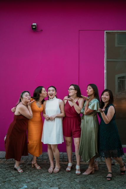 Wandersoul Stories Bachelorette Party Photos - bride with friends in lisbon pink wall