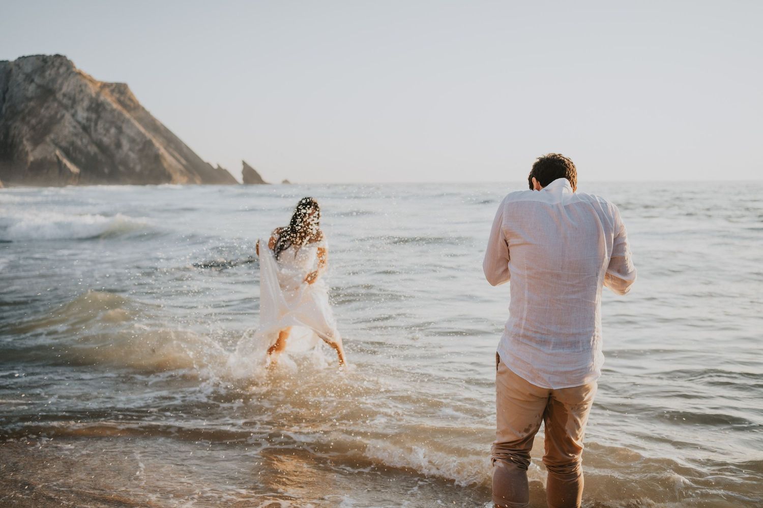 Wandersoul Stories Elopements and Destination Weddings Portugal - Wedding at the beach - couple playing in the water