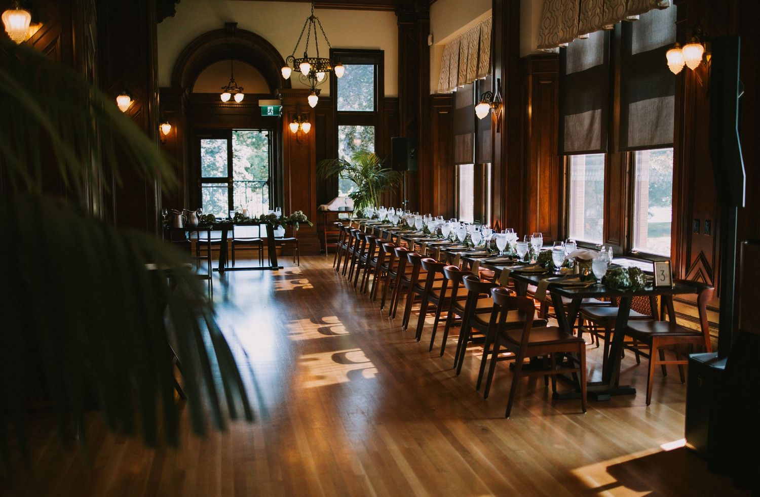 A rustic wedding reception venue with wooden floors and warm lighting creating an intimate atmosphere.