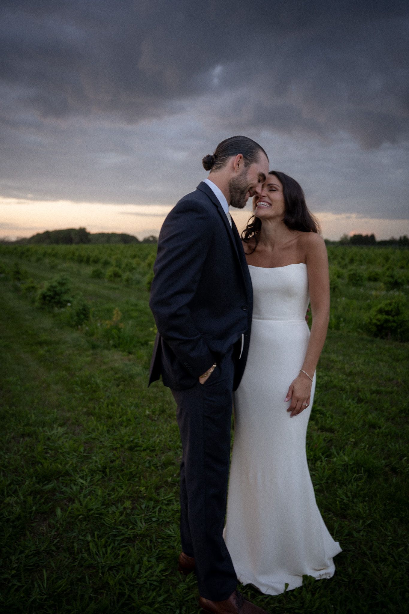 Bride and groom sharing a golden hour moment in the vineyard fields in Hamptns, NY