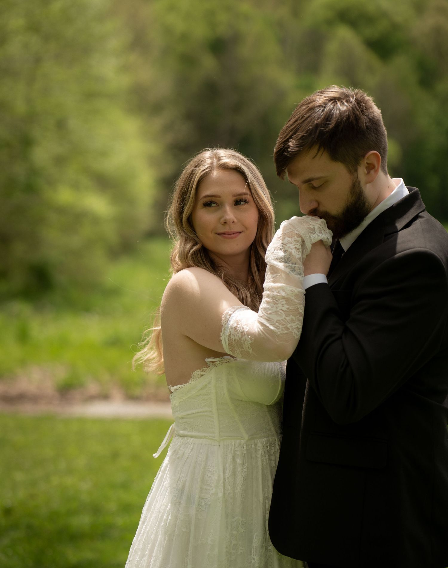 Bride and groom sharing a soft, romantic moment in the woods during their New York elopement
