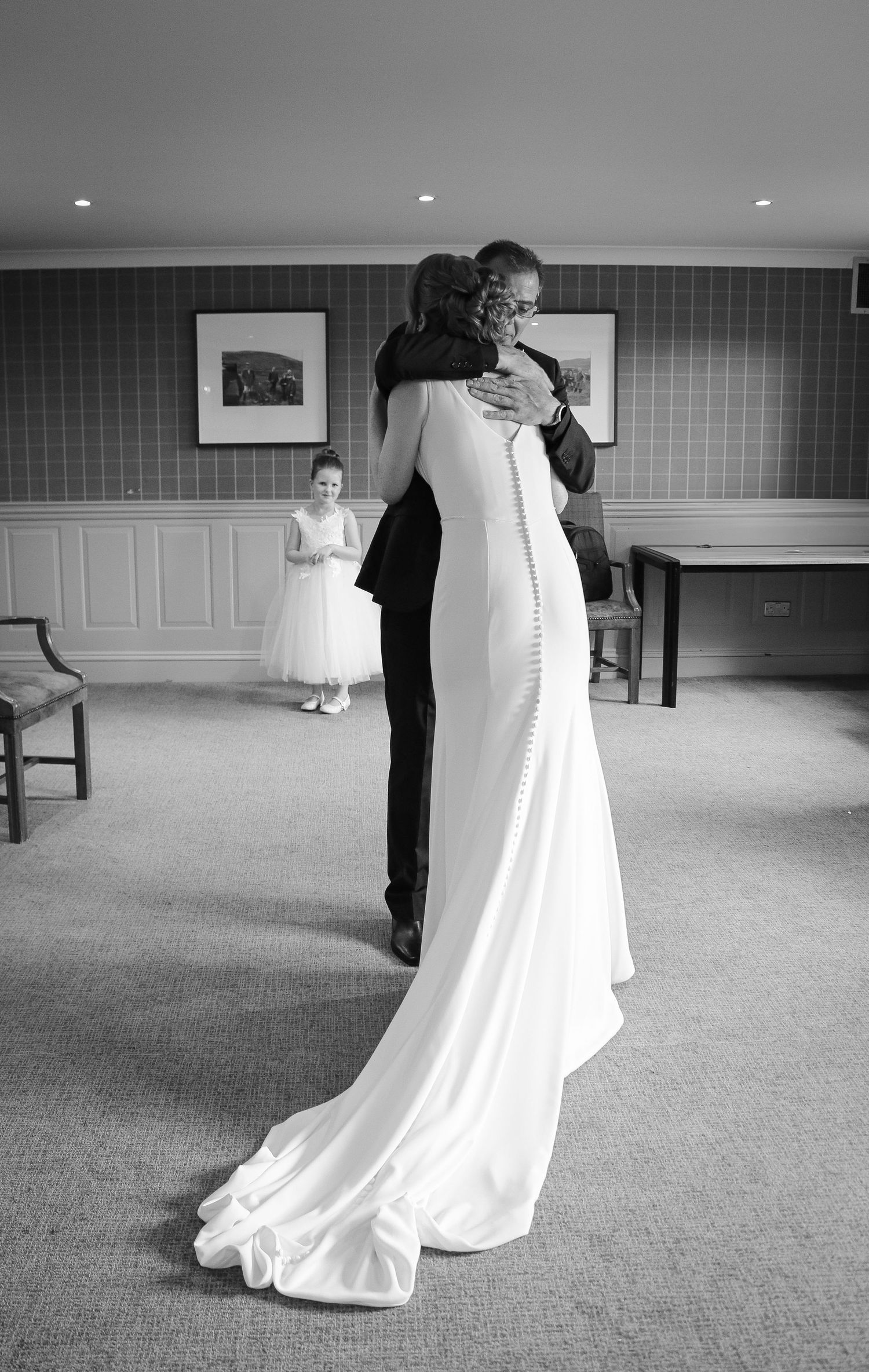 A black and white photo sequence shows a couple's first dance moment at their wedding reception.