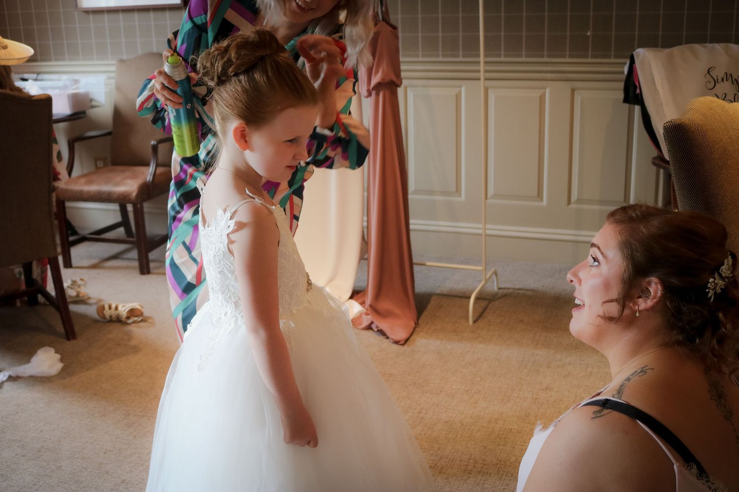 A sequence of photos shows emotional moments during a wedding as family members share heartfelt embraces.