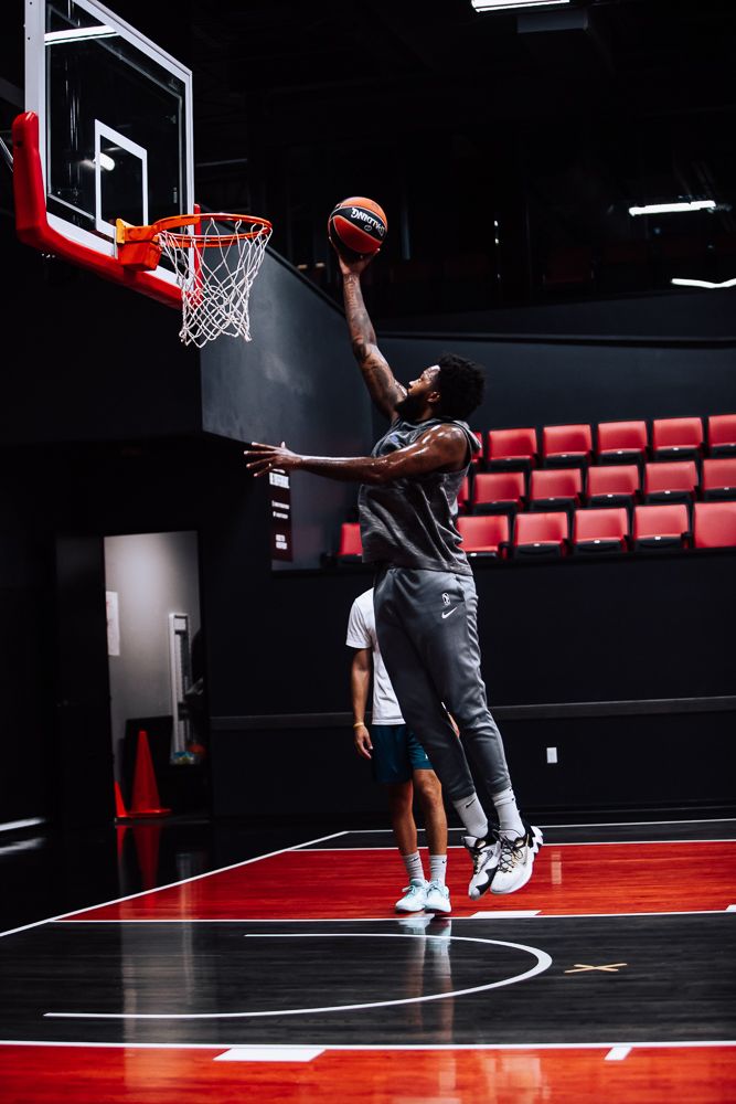 Dynamic basketball sequence showing player practicing layups and dunks on indoor court with red seating.