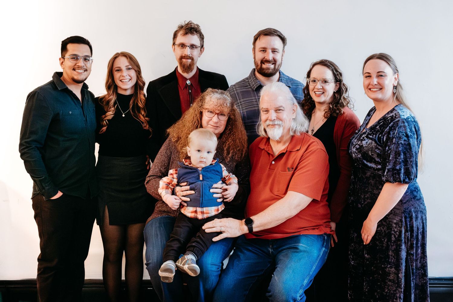 Multi generational photo of parents, adult children, their partners and one grand child in studio in Denver.