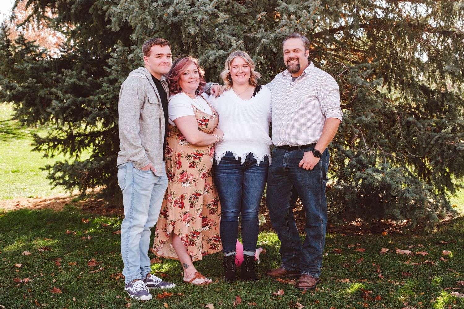 Small family grouping of family of four in extended family photo session at Denver metro area park.