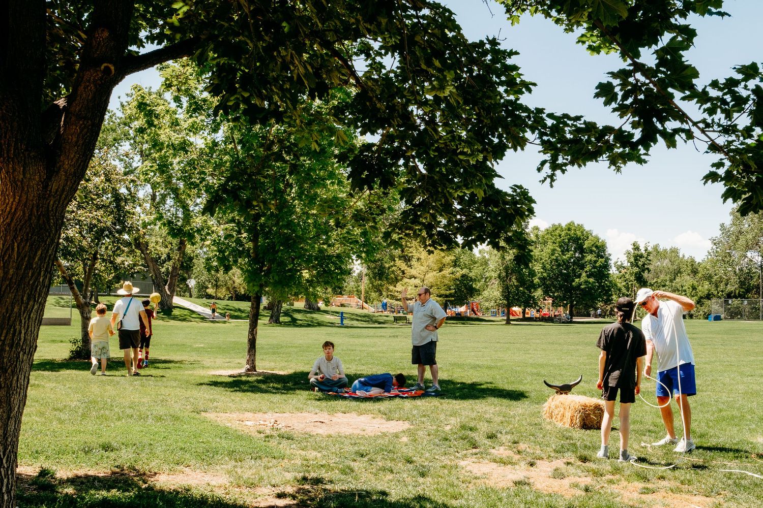 Families playing yard games at Summer BBQ with Wilderness Inclusion for Learning and Development, Littleton nonprofit.