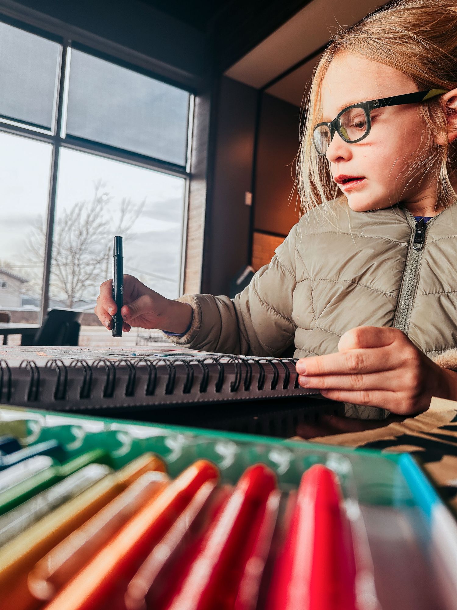 Denver photographer project 365 - young girl coloring with markers at coffee shop
