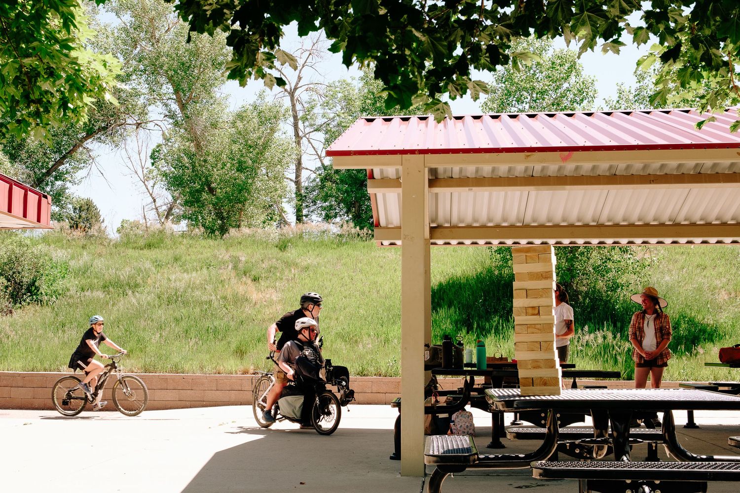 Family riding bikes into park in Centennial, Co