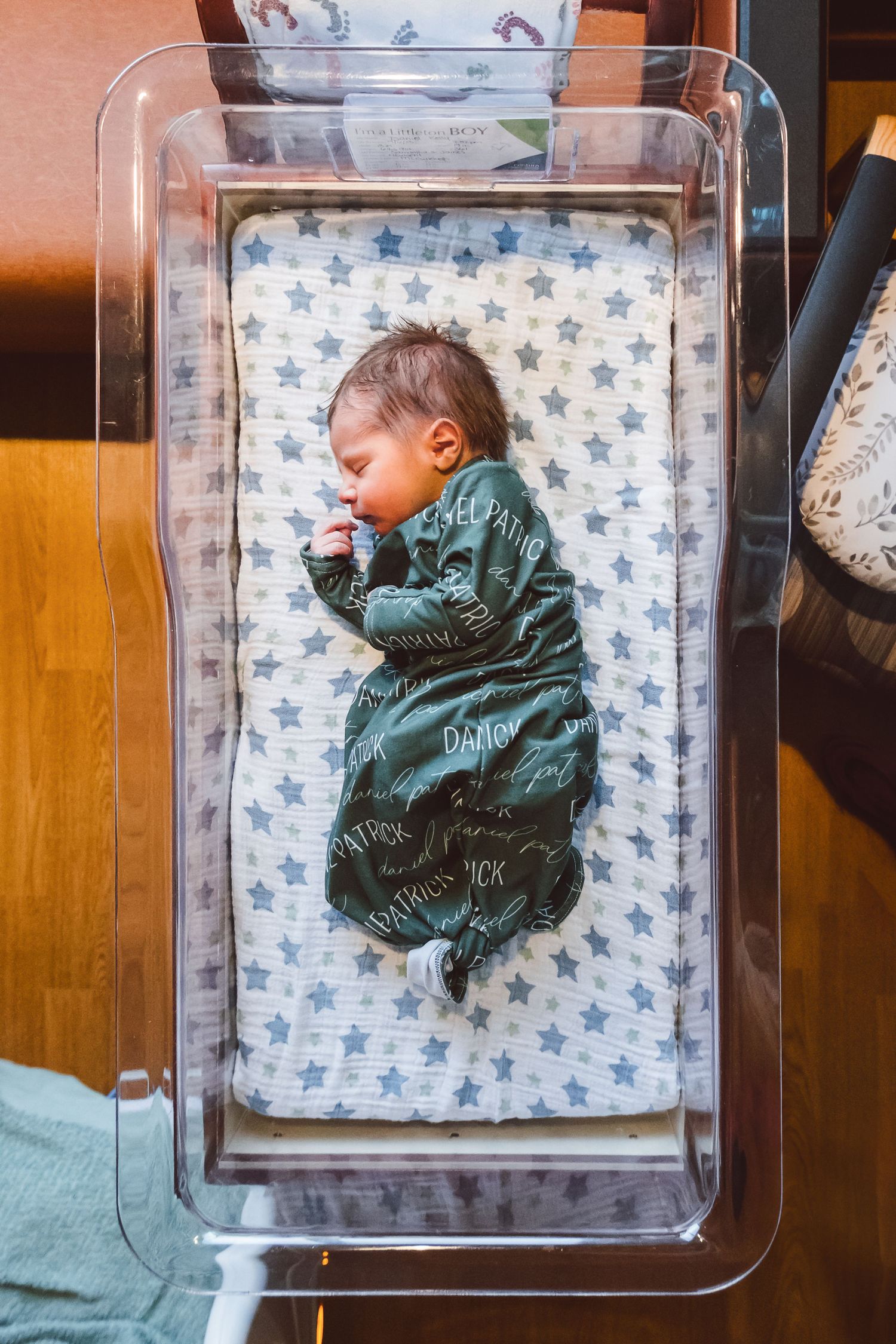 Newborn portrait of baby boy sleeping peacefully in hospital basinet.