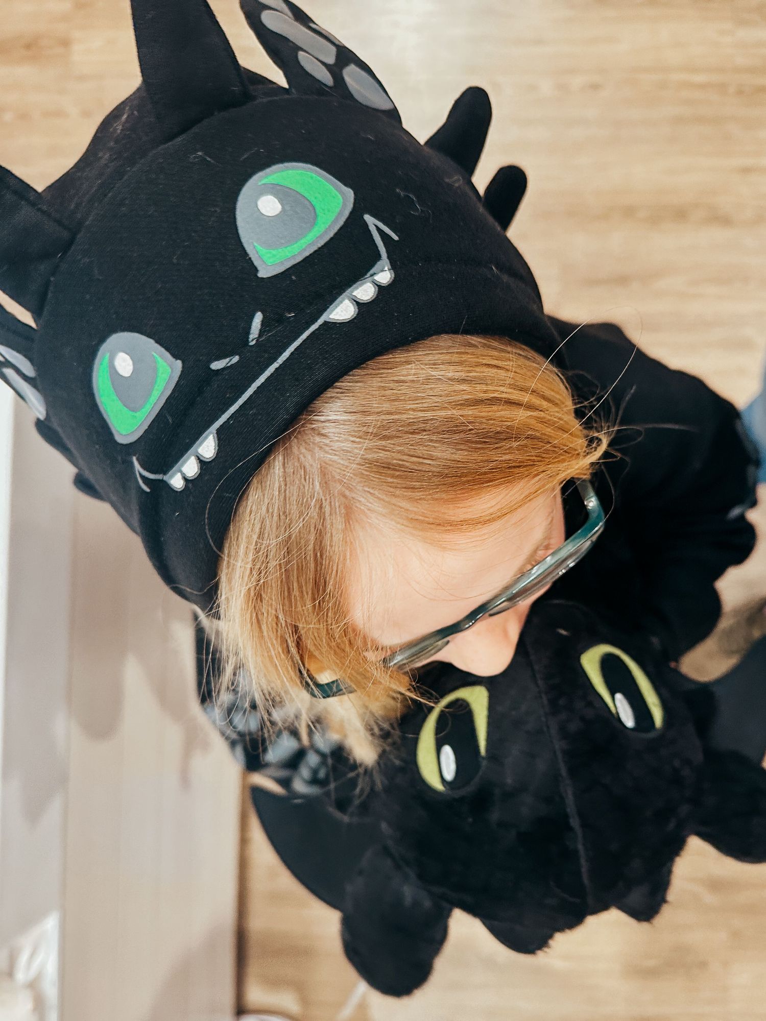 Denver photographer project 365 - young girl wearing Toothless hoodie, holding toothless plushy