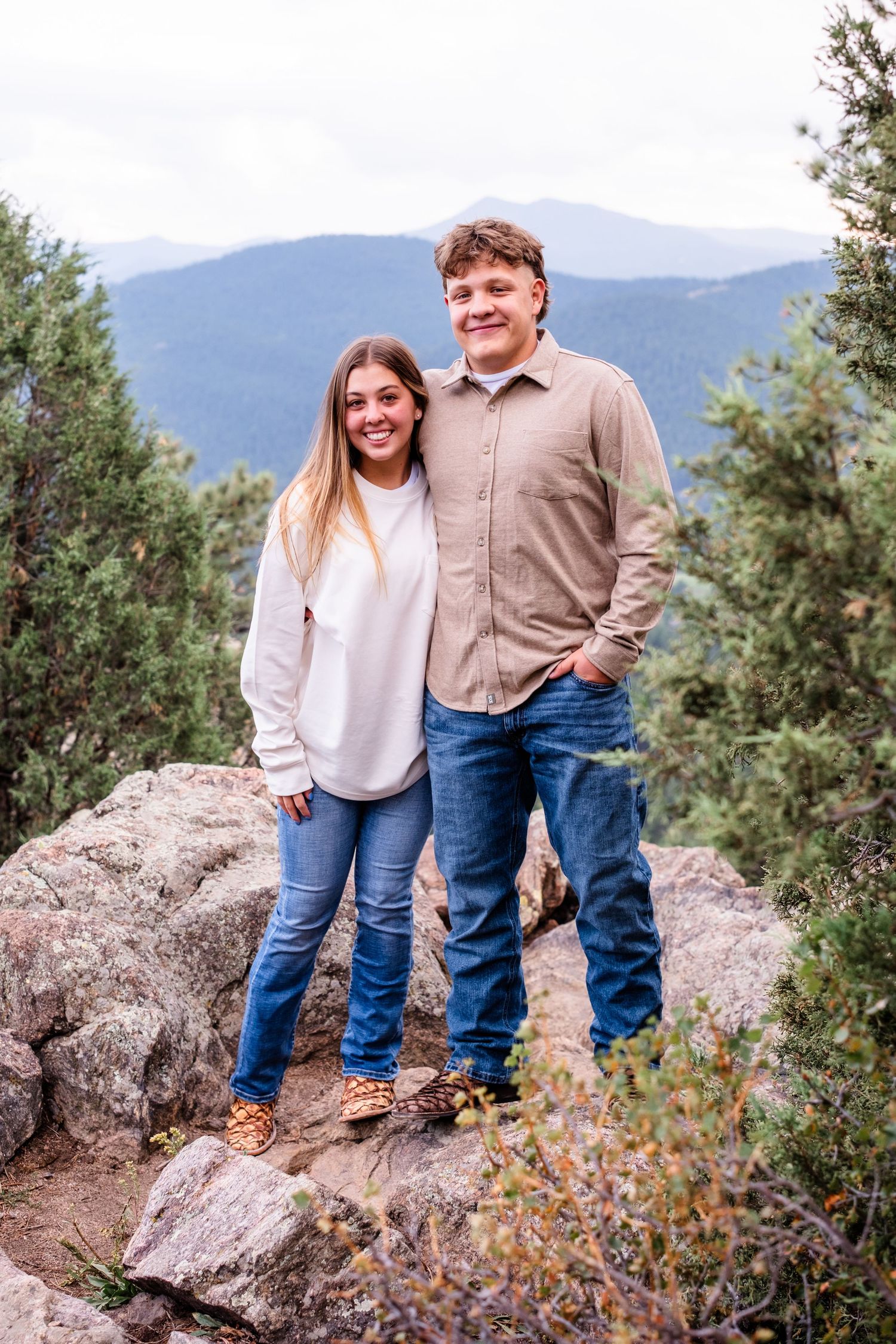Young couple standing in rocky area at Mount Falcon West.