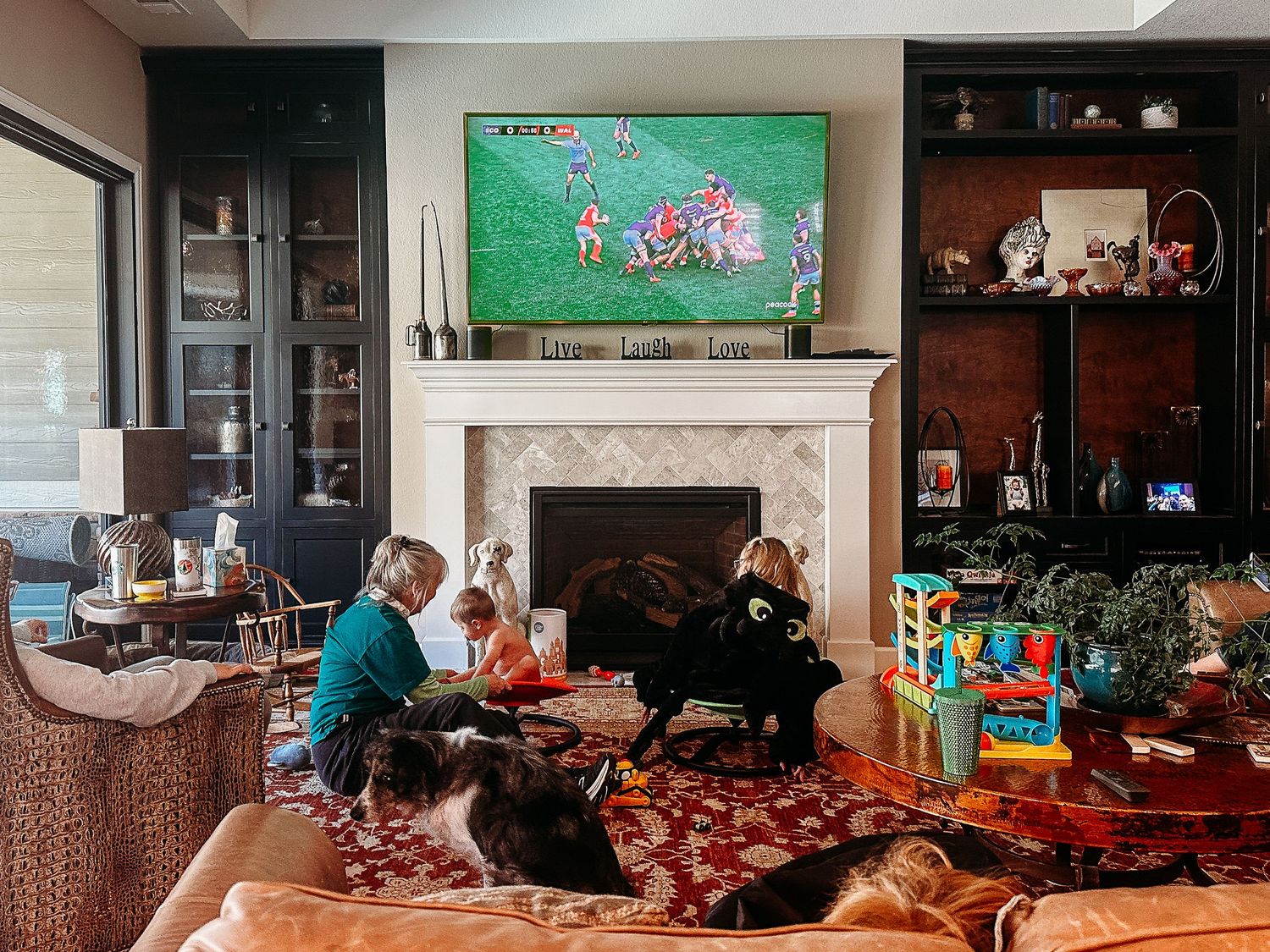 Living room of family watching rugby on TV.