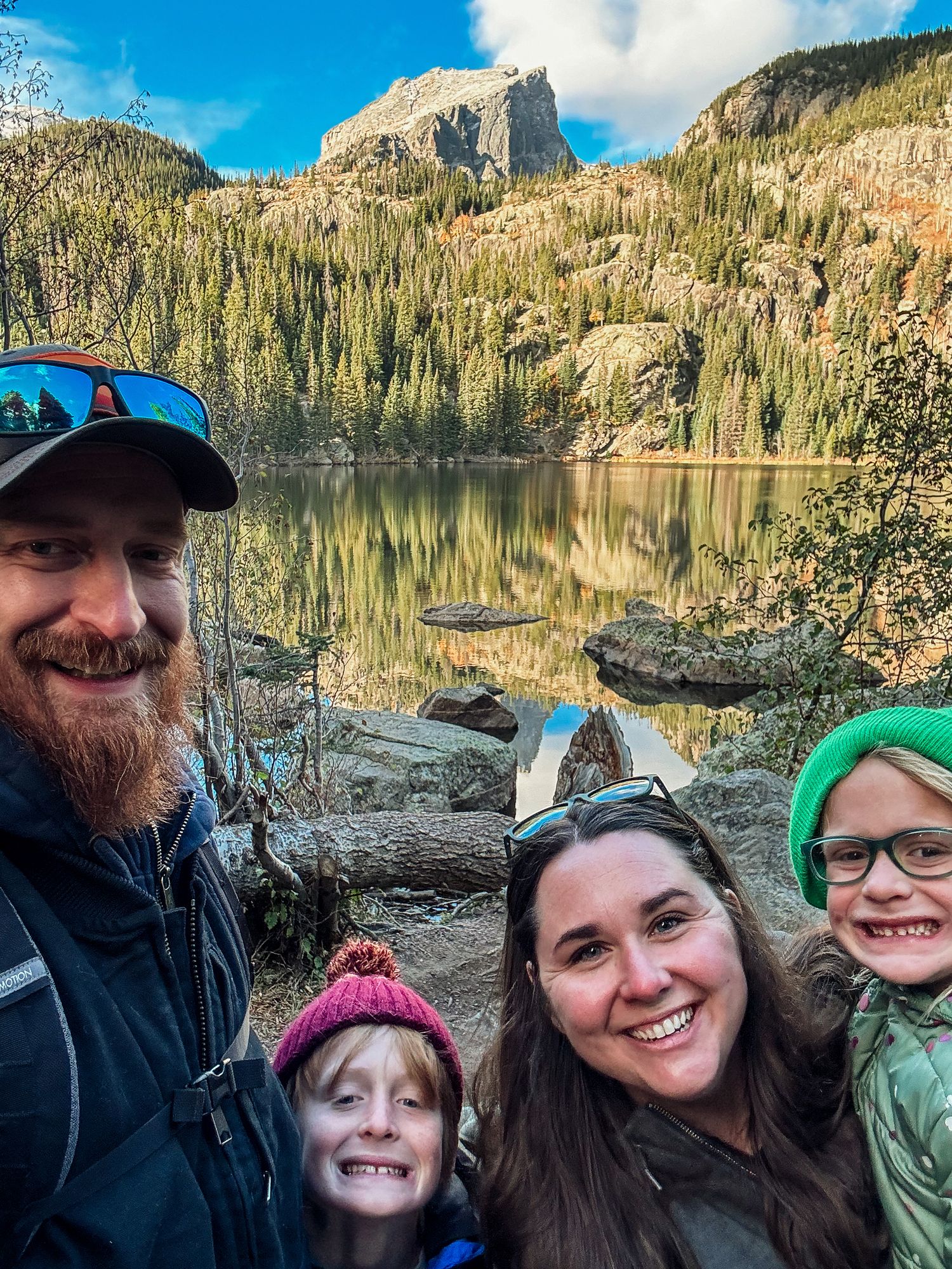 Family of four on fall hike at Bear Lake in Rocky Mountain National Park.