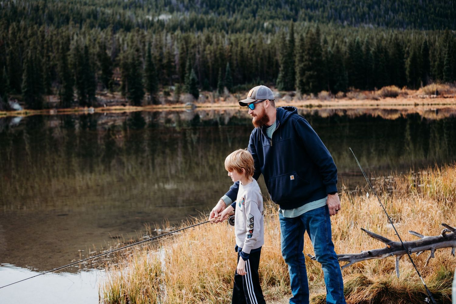 Father and son fishing at Sprague lake Rocky Mountain National Park.
