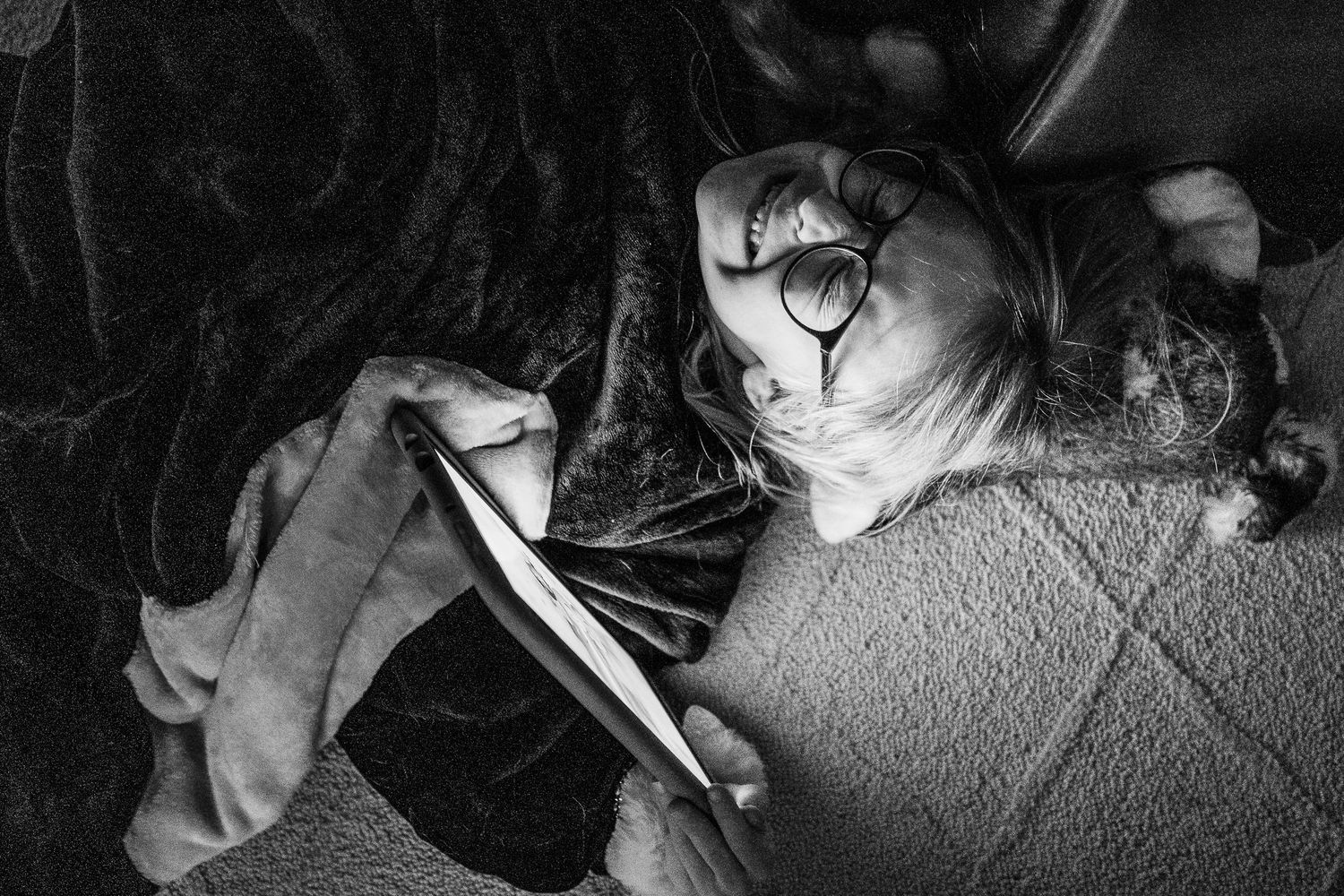 Denver photographer project 365 black and white photo of young girl playing on device