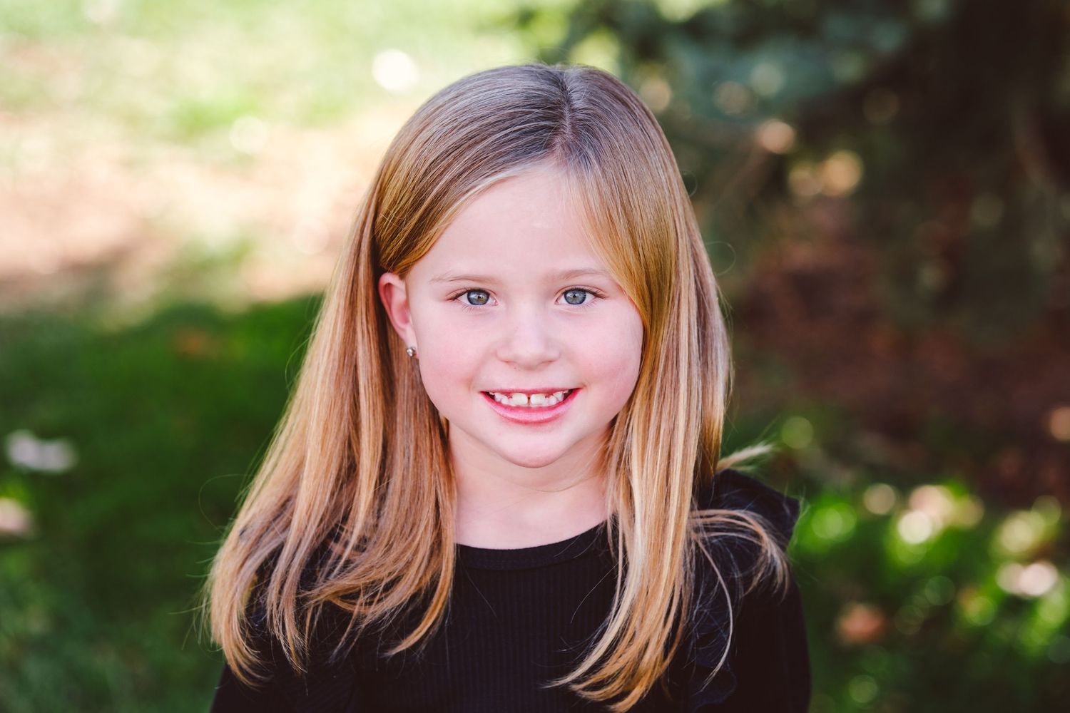 Portrait of young girl, smiling at camera.