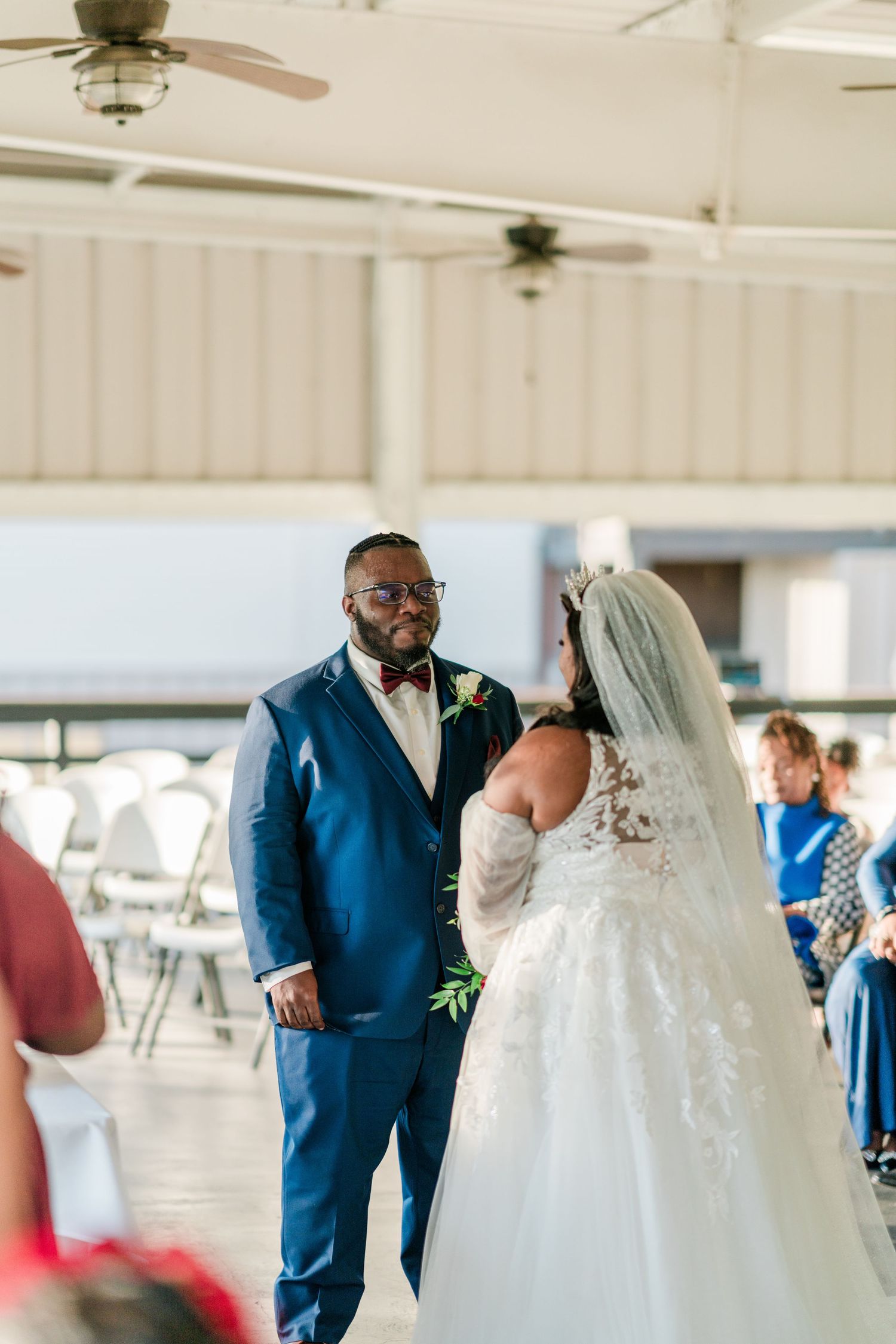 Wedding celebration taking place in a covered venue with elegant decor and lighting.