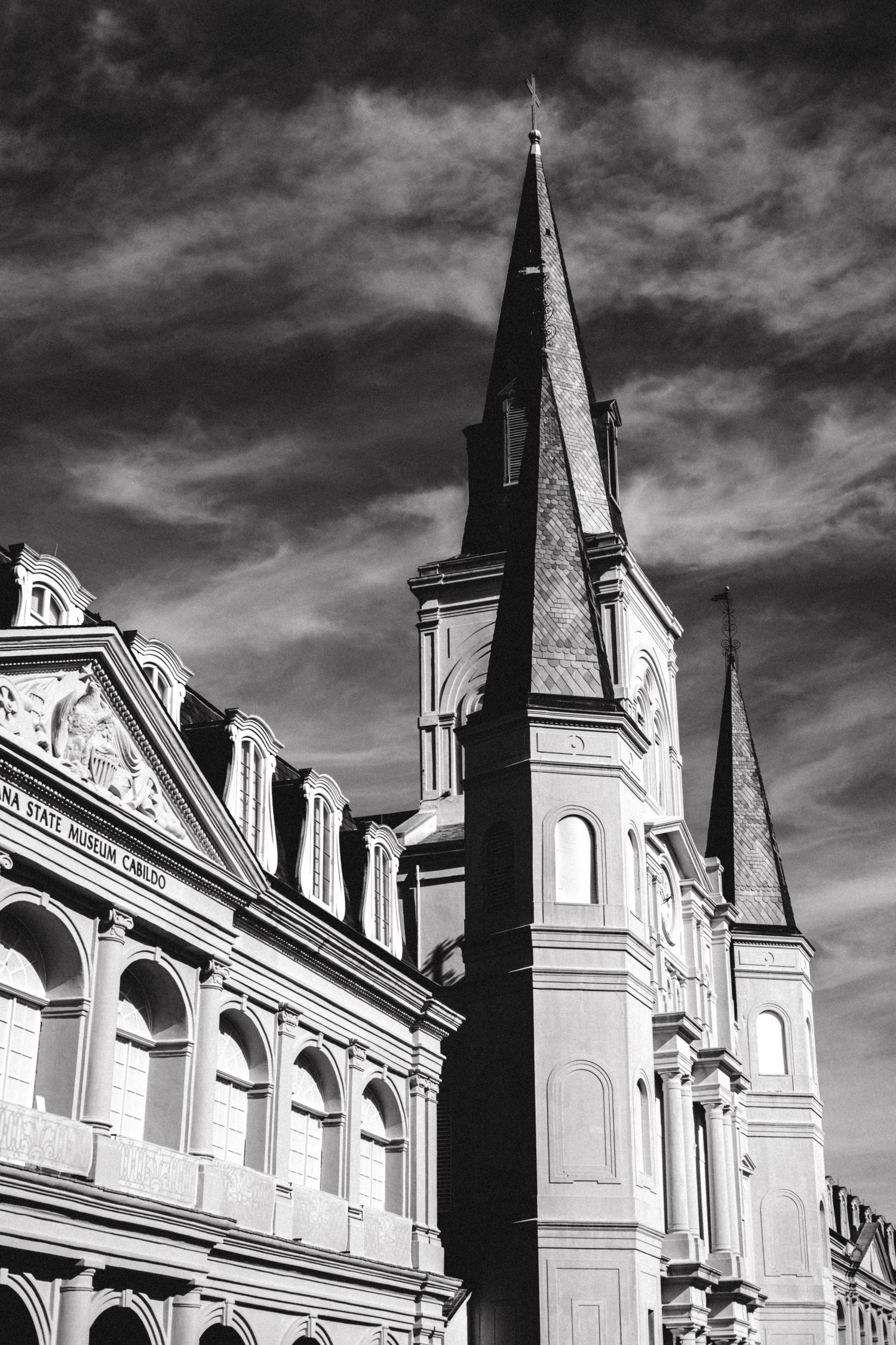 Dramatic angular perspective of St. Louis Cathedral architecture in black and white.