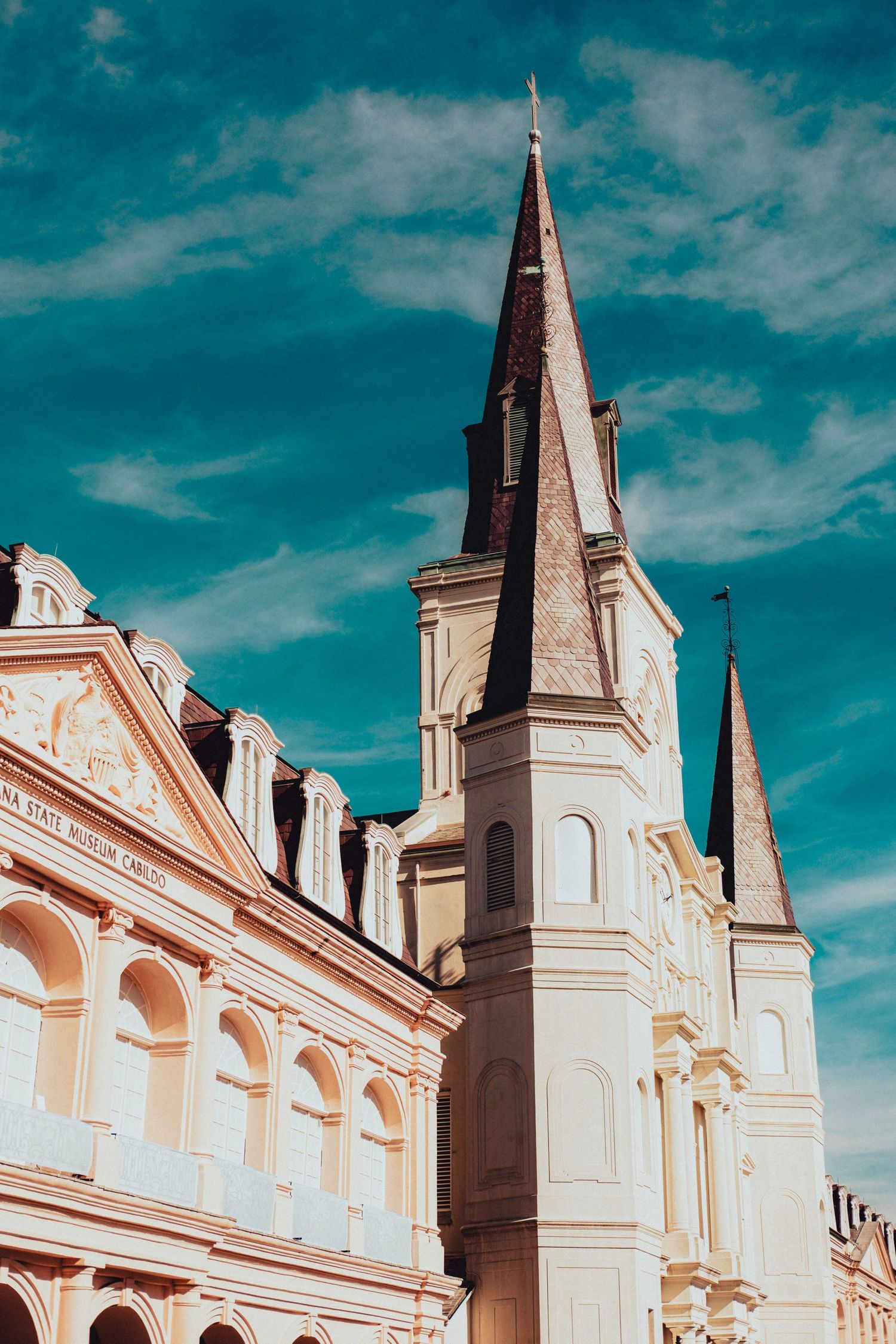 St. Louis Cathedral in New Orleans with dramatic turquoise sky and ornate architecture.