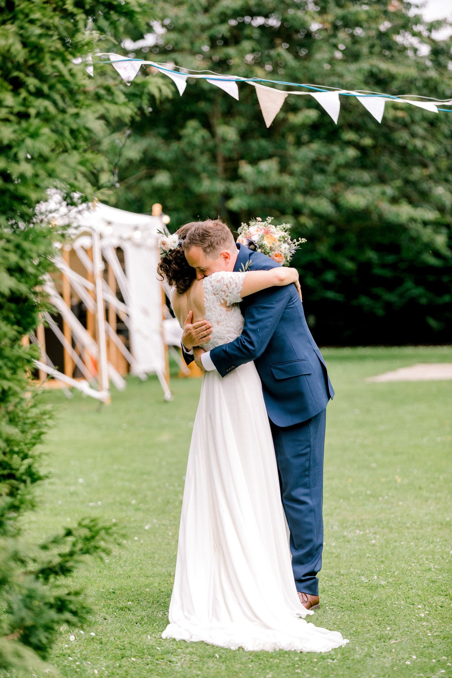 Bride and groom sharing intimate moment post ceremony summer garden wedding