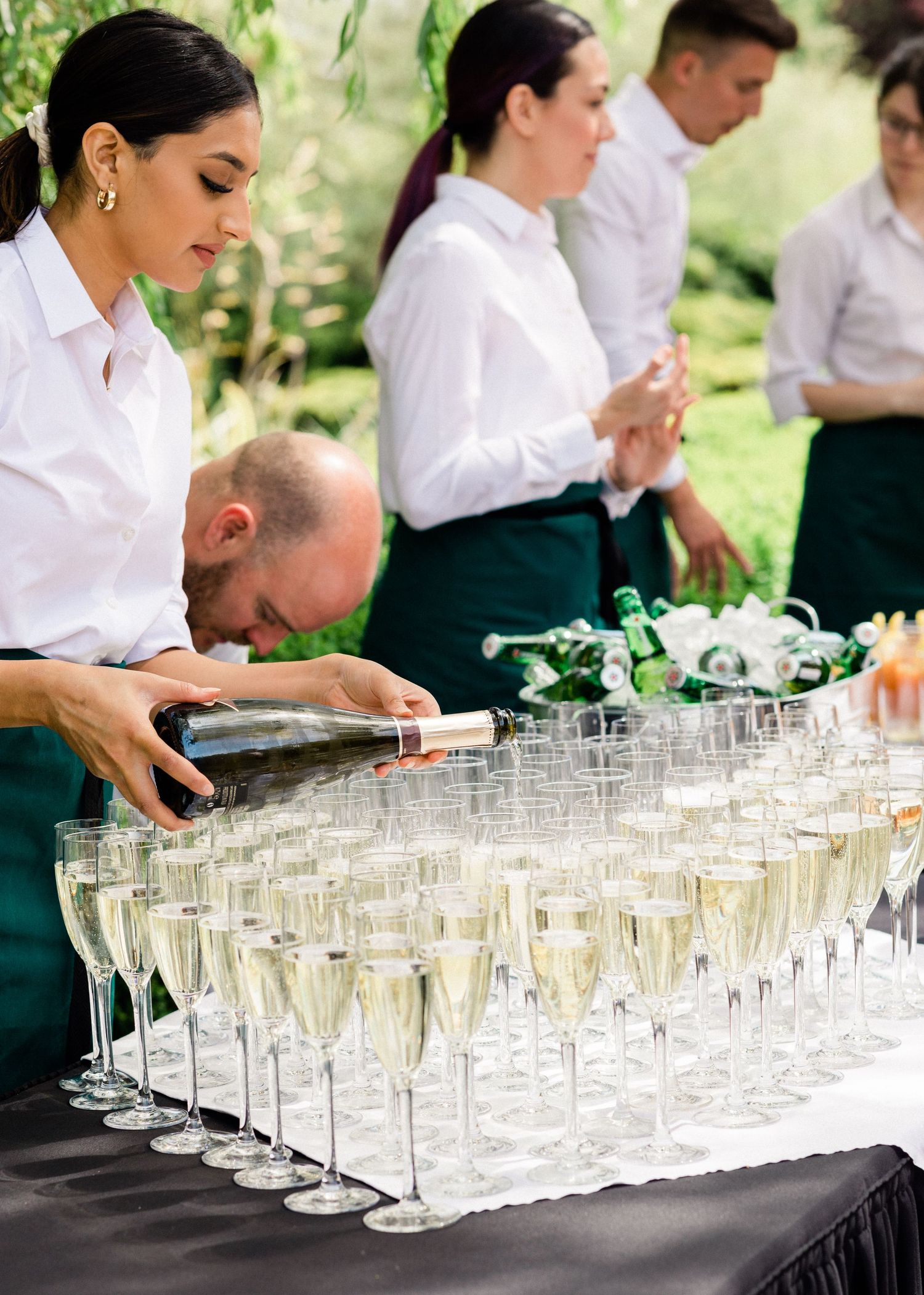 Wedding reception detail shot of prosecco being poured into glass by venue staff in Kent venue