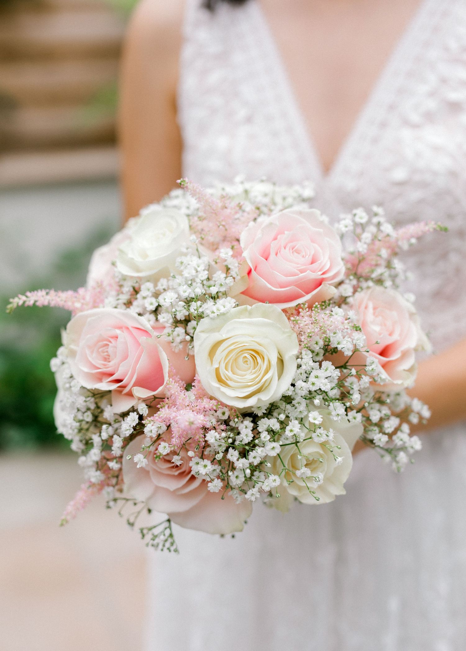 Wedding bouquet detail shot with bride's hands holding elegant flower arrangement in London