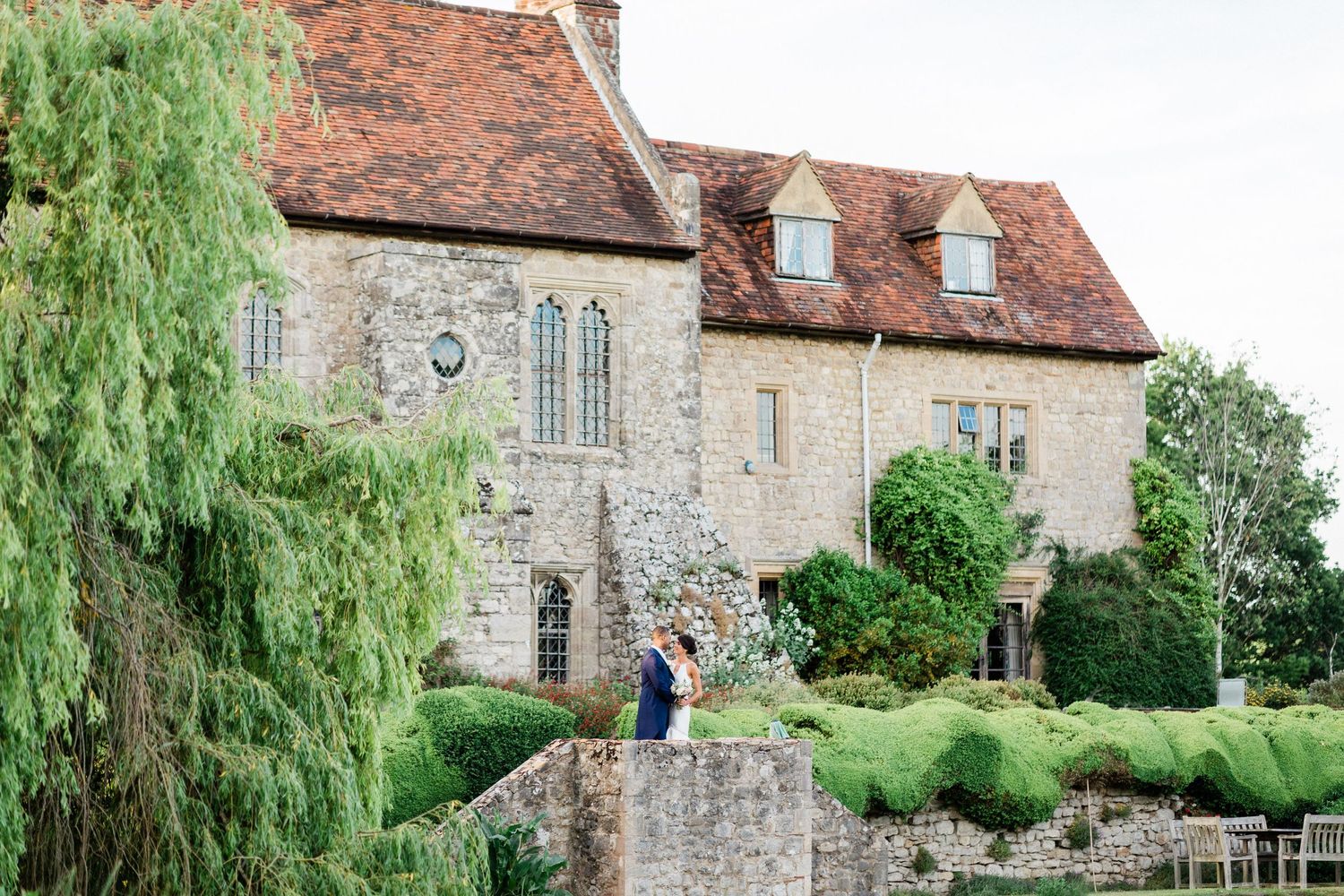 Bride and groom portrait photographed from distance showing couple at Kent wedding venue