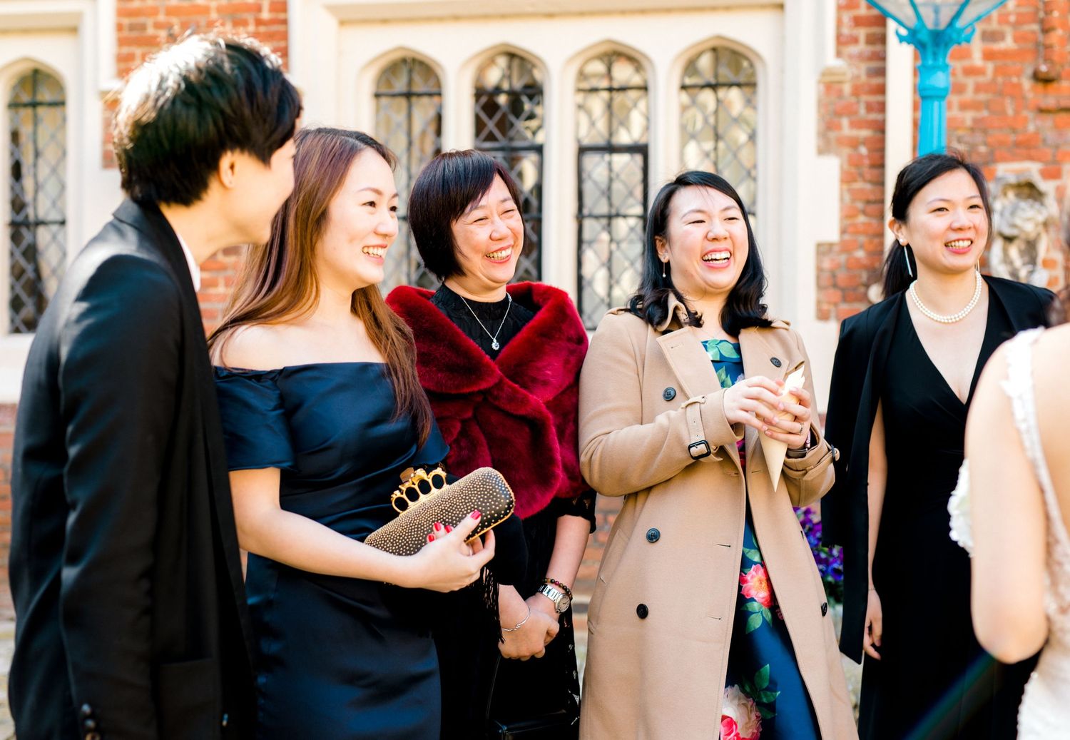 Candid wedding reception photography capturing guests chatting and enjoying celebration in Gosfield Hall Essex