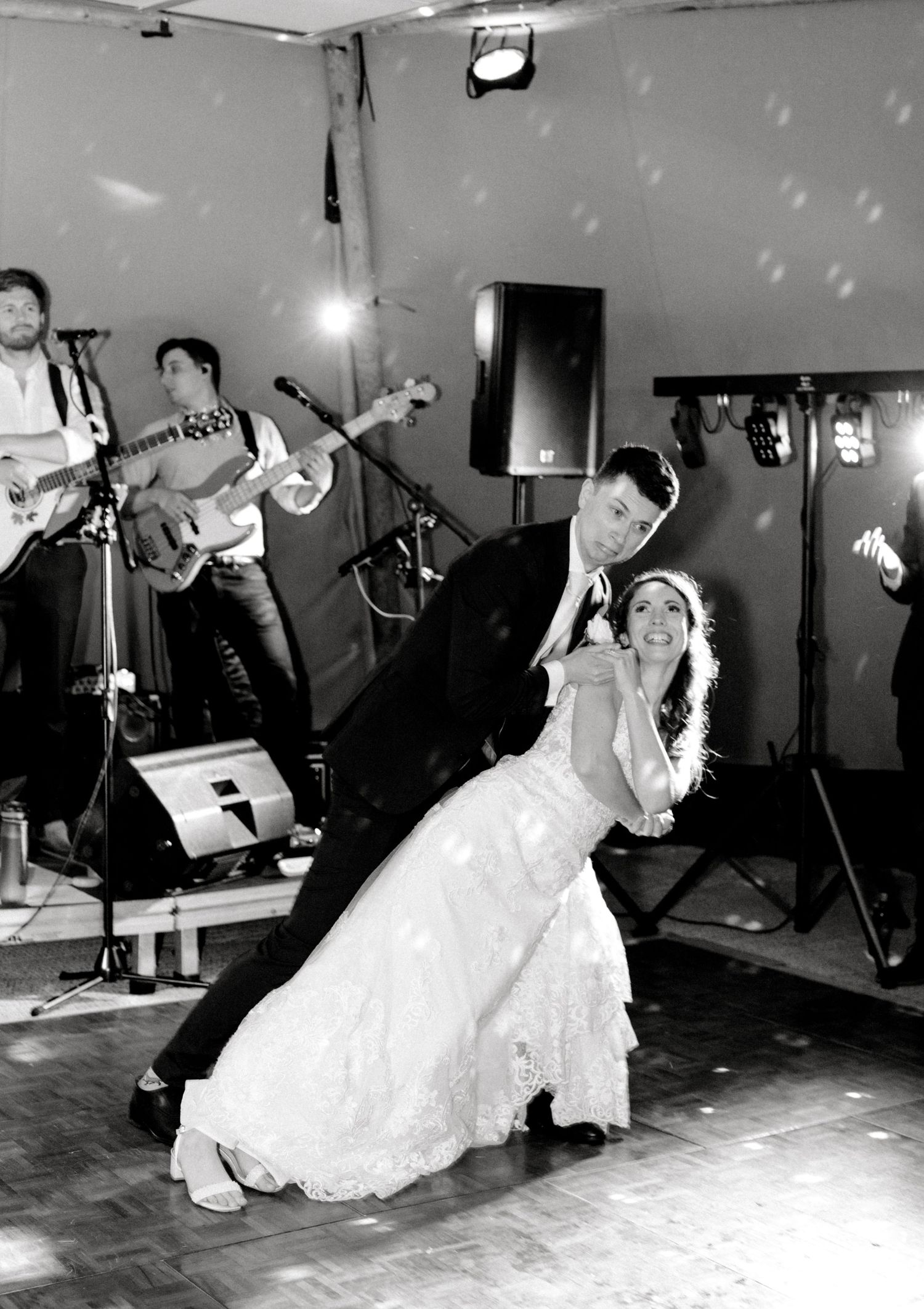 Newlyweds enjoying playful first dance moment with smiles and laughter at wedding in Kent