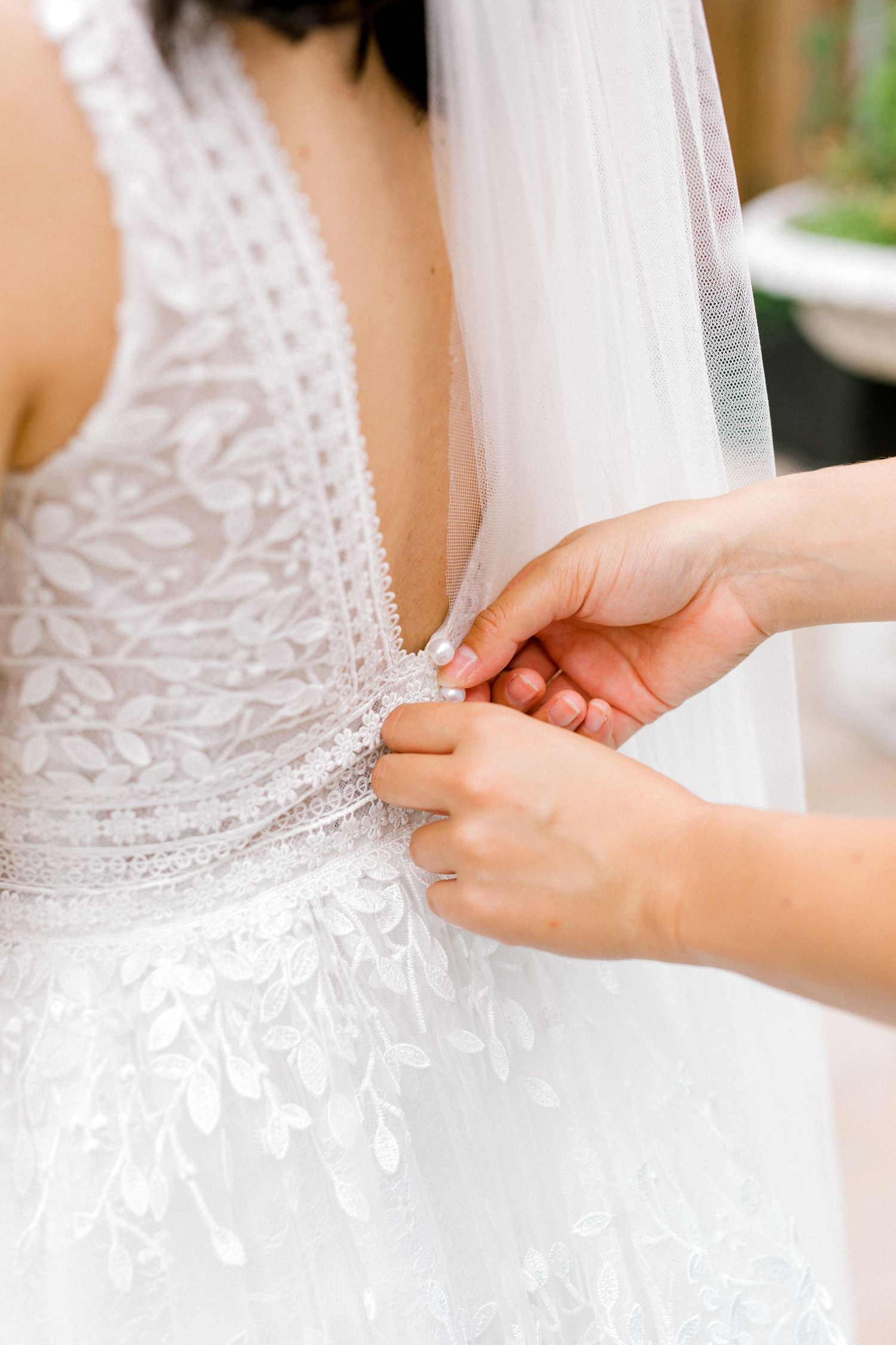 Back of the dress showing tiny satin buttons romantic wedding morning details - London wedding photography