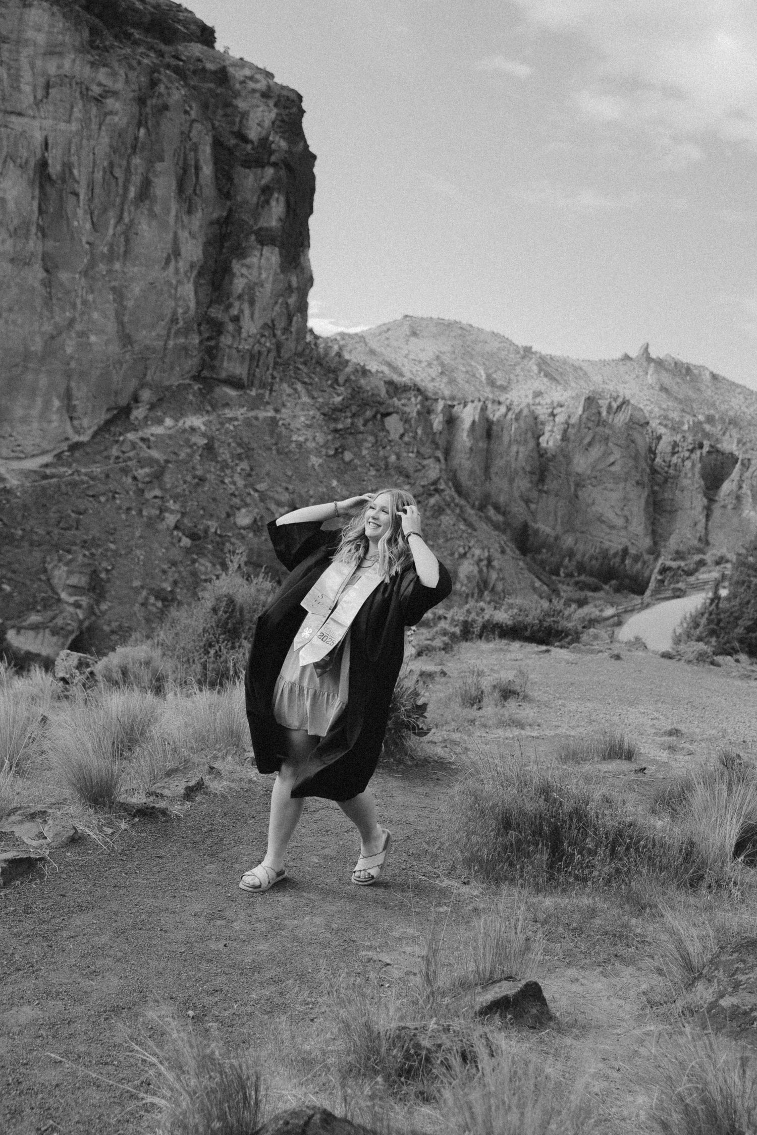 Artistic black and white photos against dramatic desert cliff backdrop.