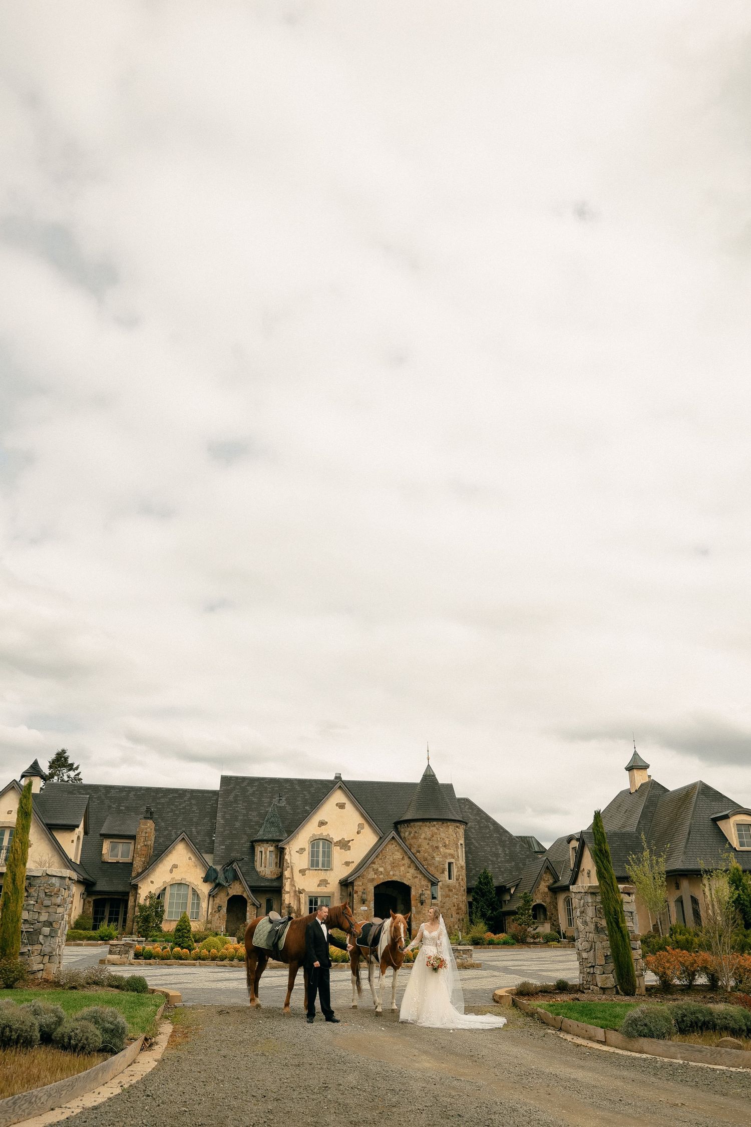 Wedding venue exterior showing stone buildings and landscaping in a residential development.