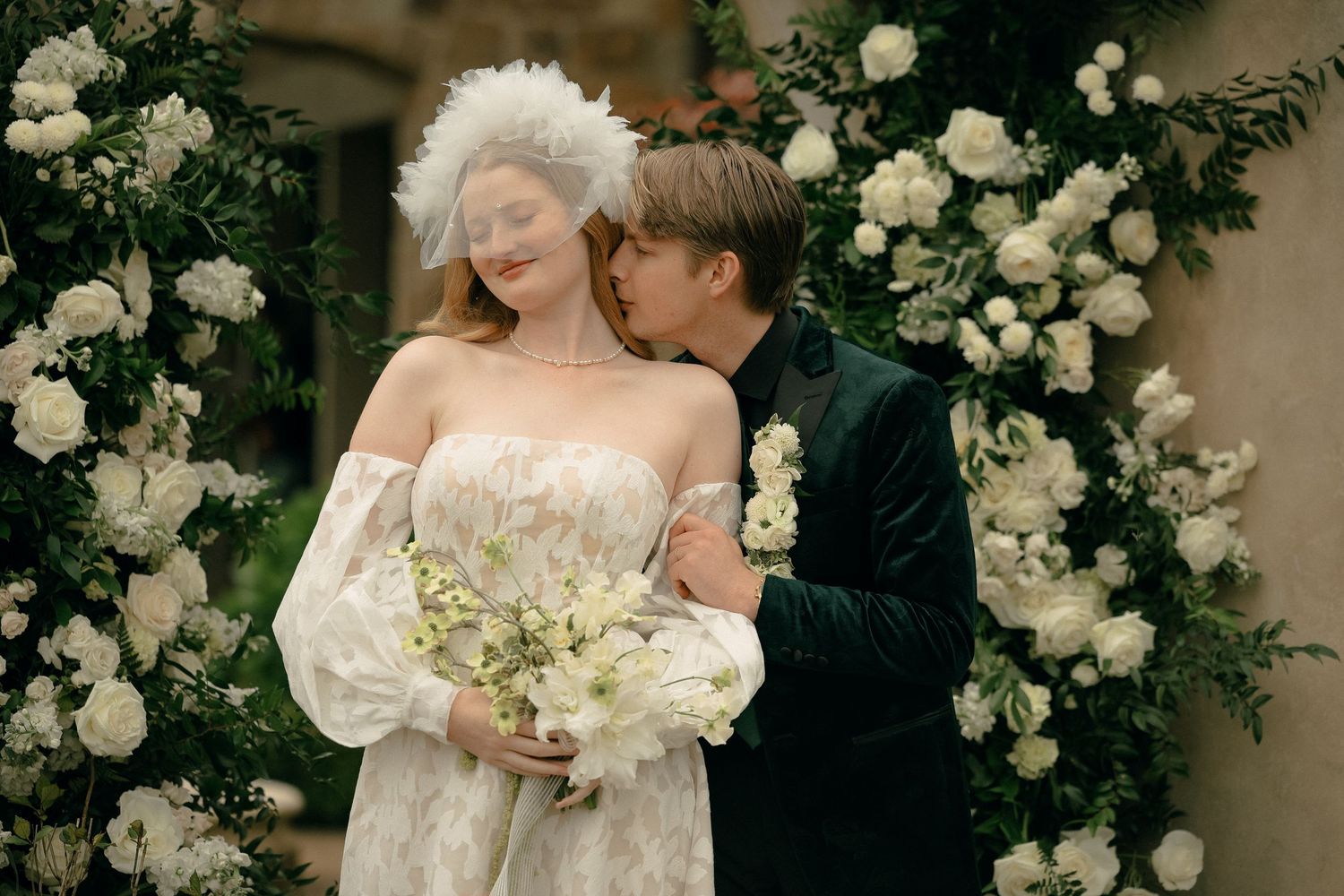 Romantic outdoor wedding photos with white floral arrangements and elegant decor.