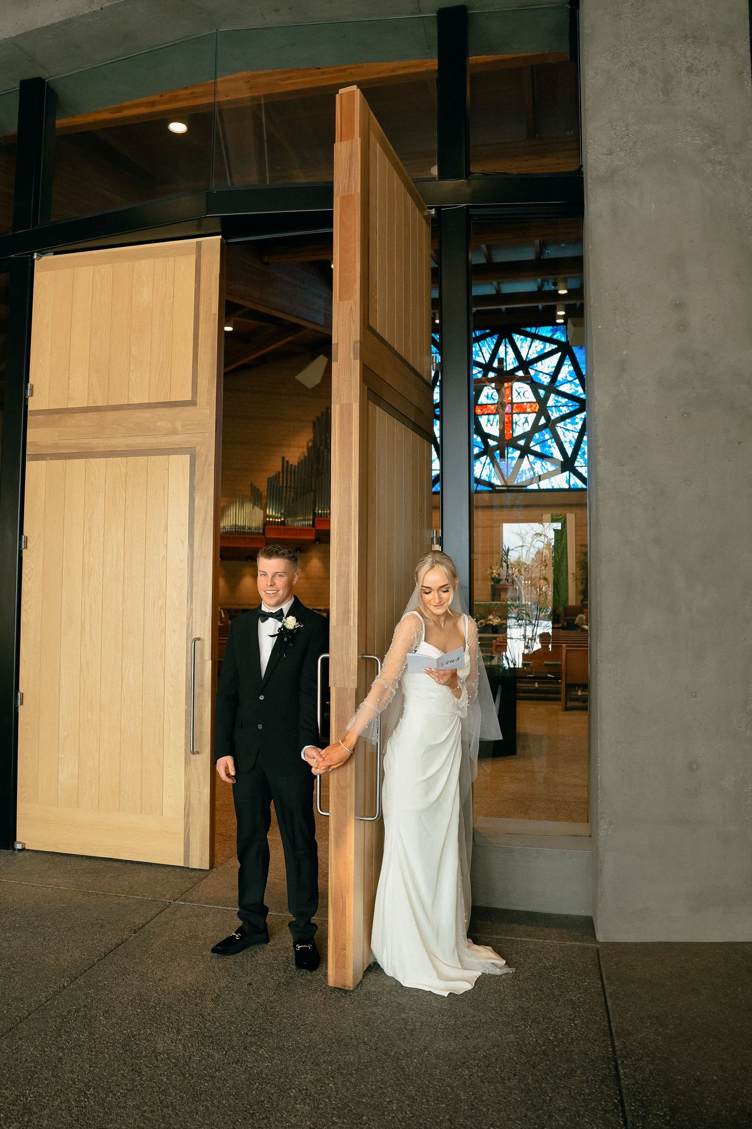 A bridal first look sequence showing the anticipation and reveal between couple through wooden doors at a venue.