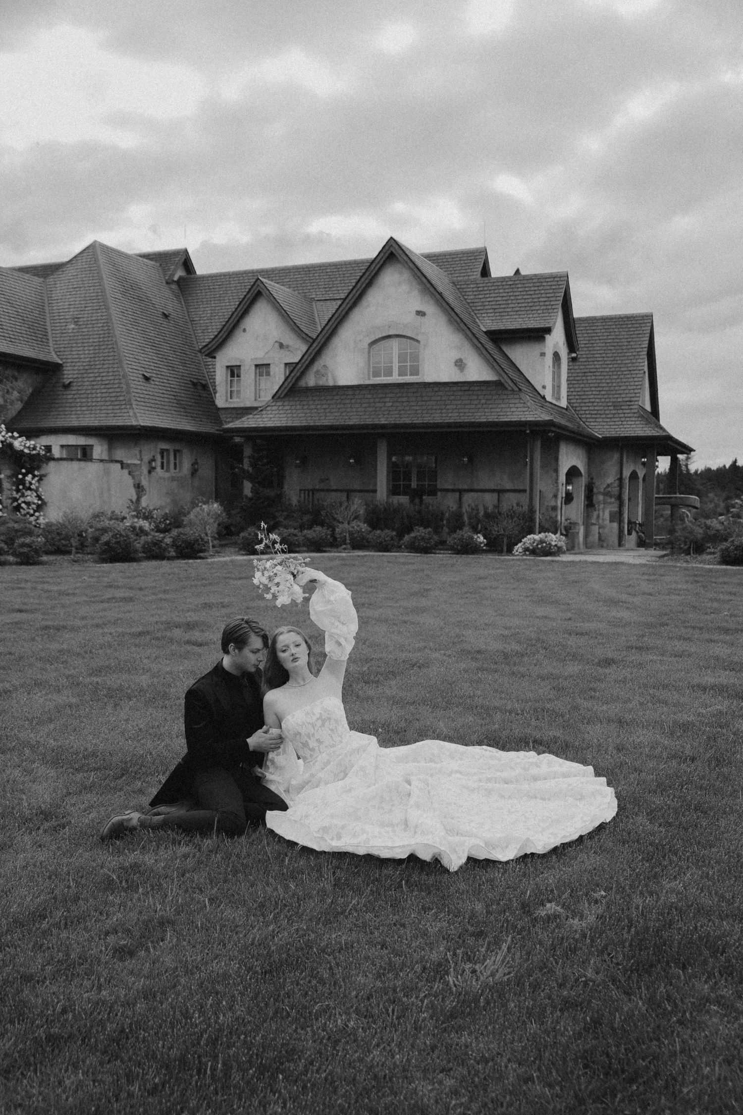 Black and white photos of newlyweds posing on grassy lawn with houses in background.