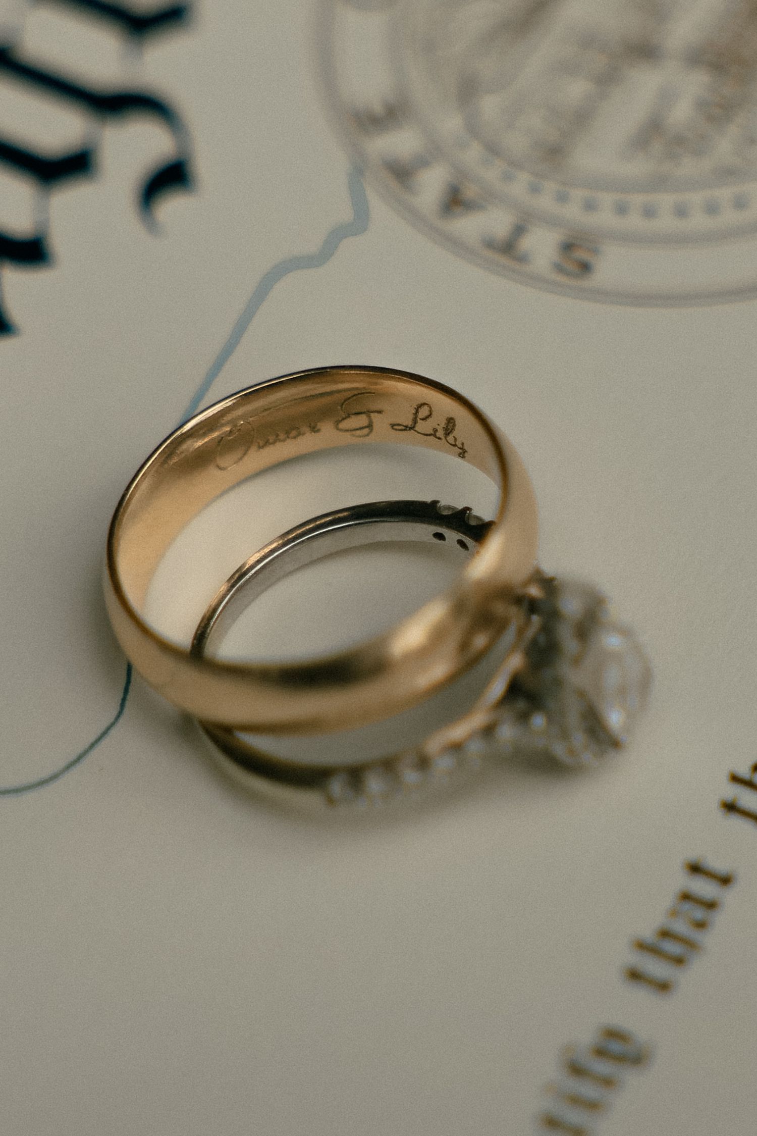 Close-up of a diamond engagement ring on a light surface.