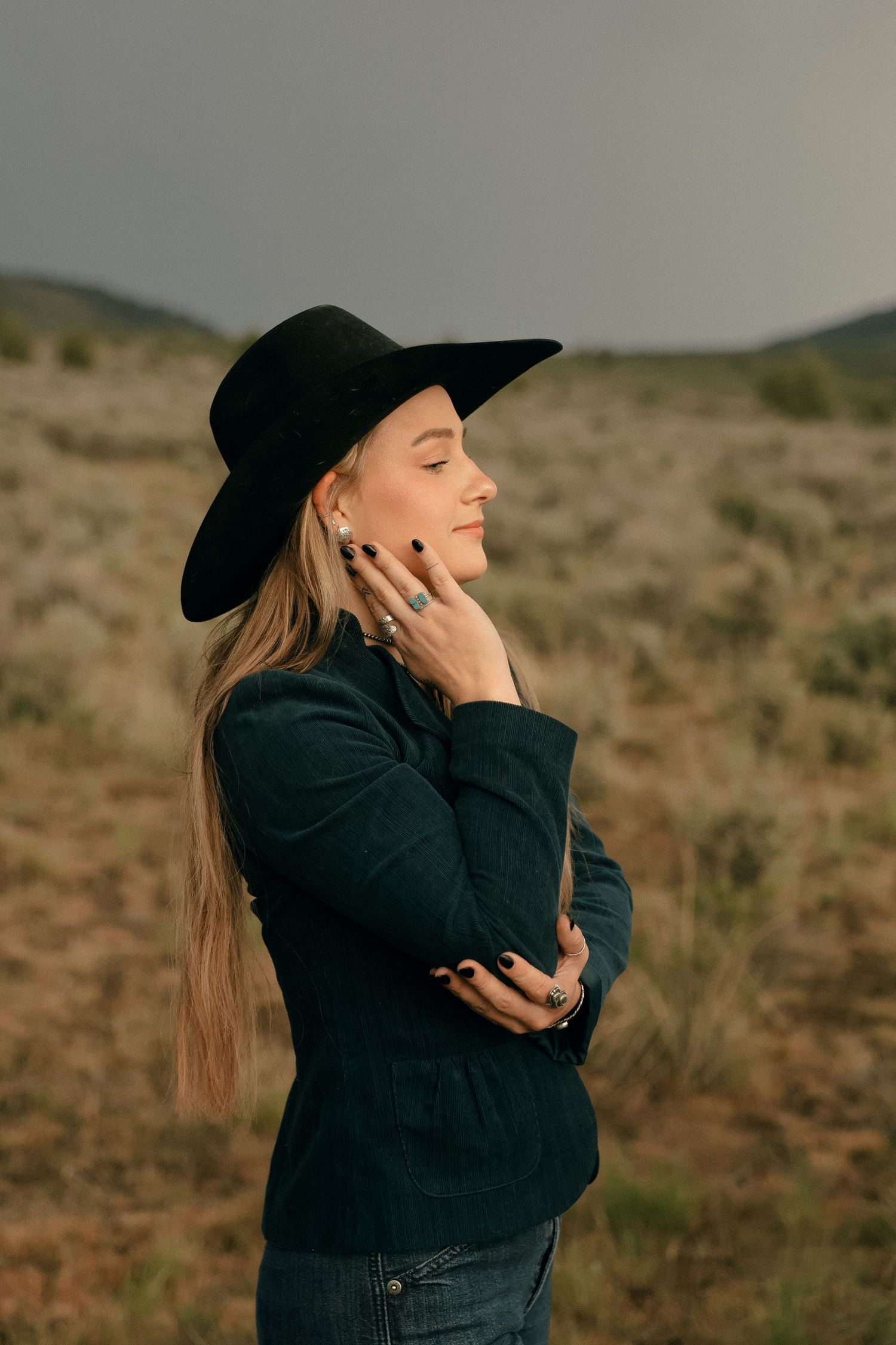 Artistic portrait series featuring a person in black attire and hat against desert backdrop.
