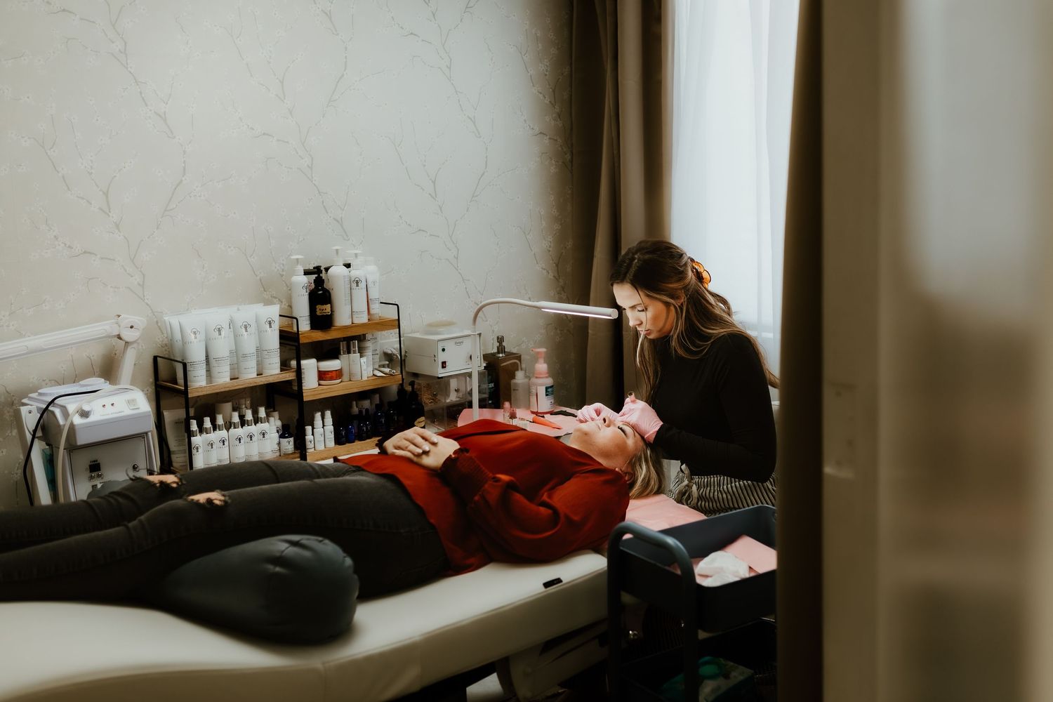 Medical treatment session in progress on massage table in professional clinic setting.