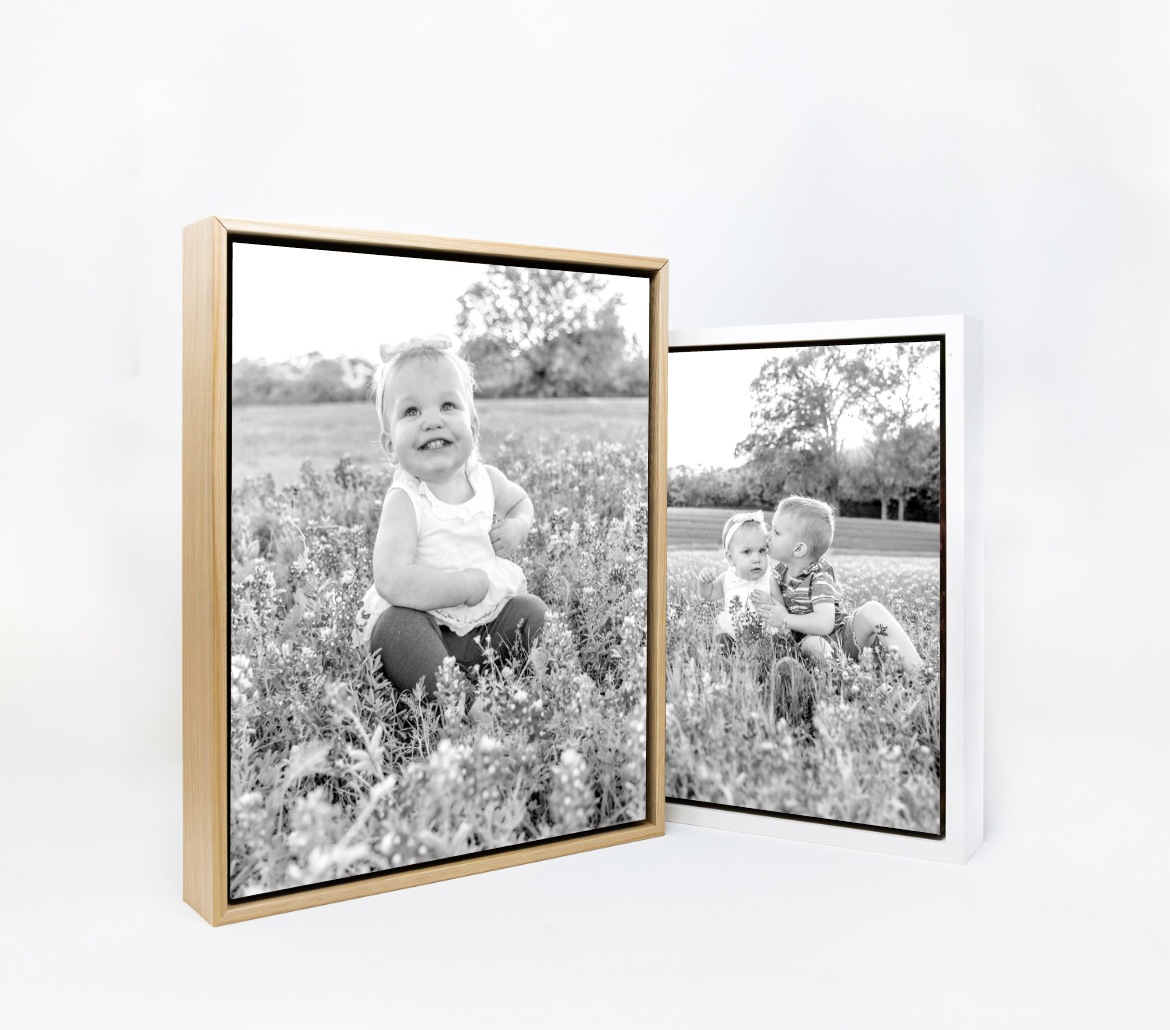 Two black and white framed photographs showing a young toddler standing in a wildflower field.