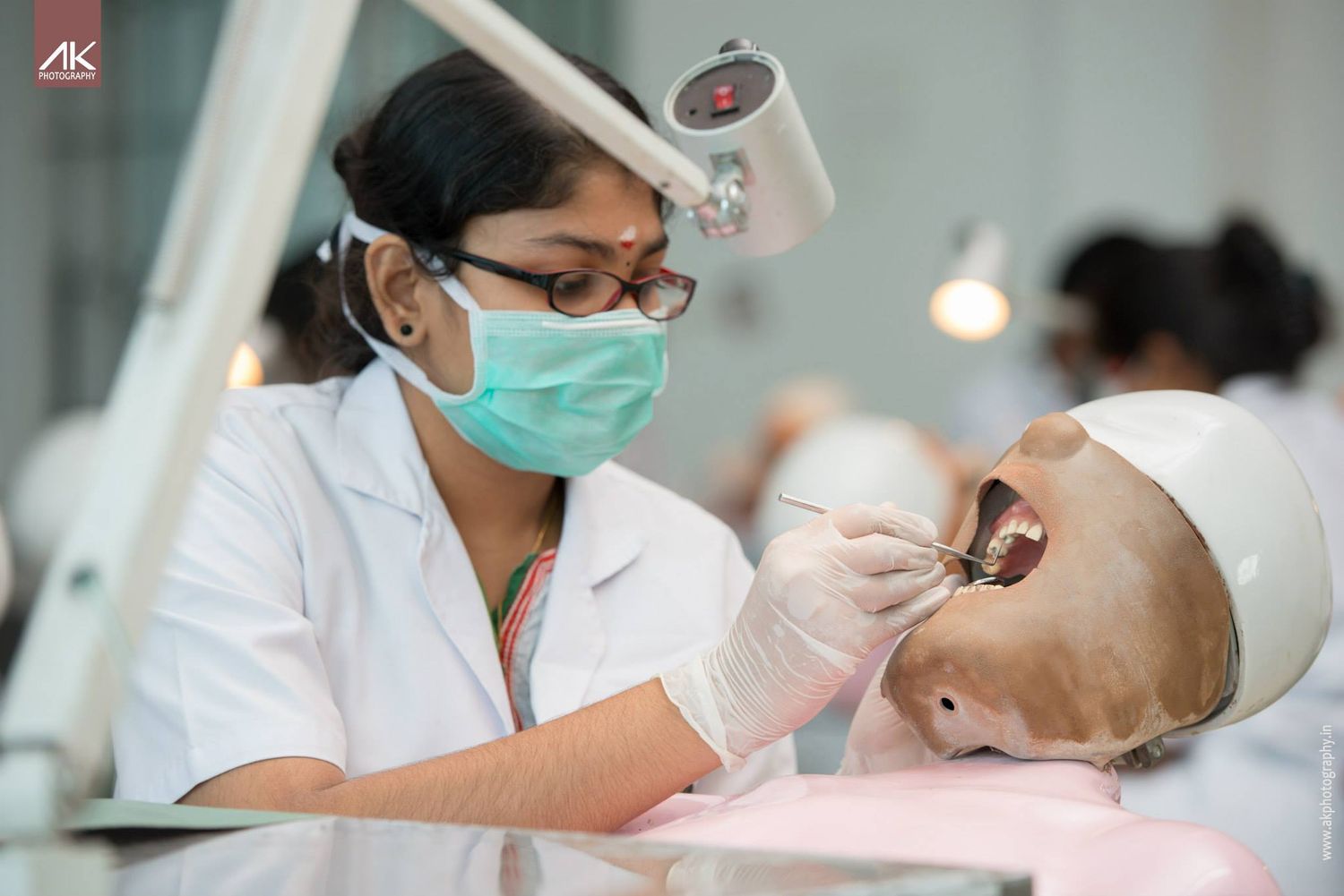 Medical professional performing a dental procedure while wearing protective gear.