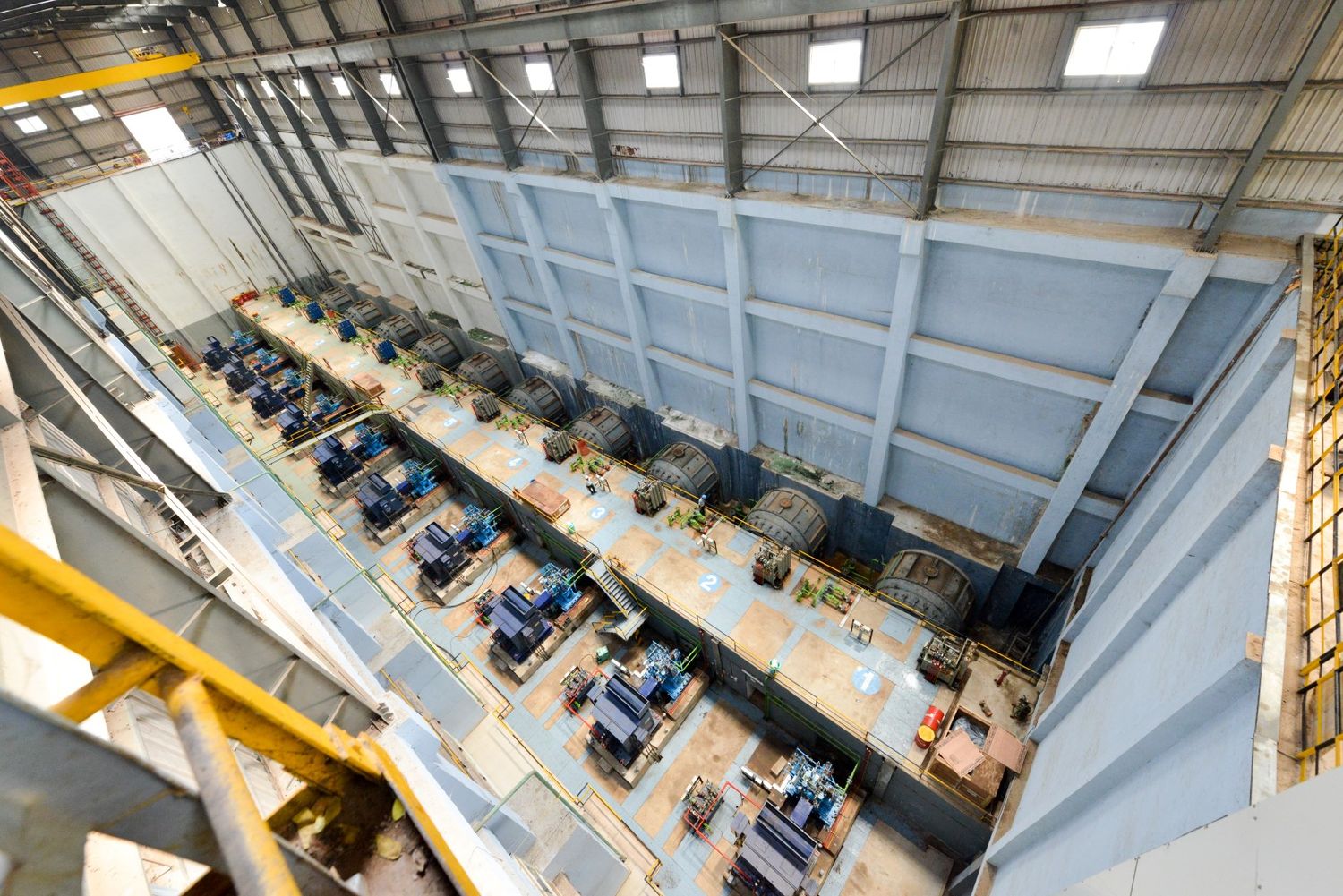 High angle view of industrial equipment arranged in rows inside a modern warehouse facility.